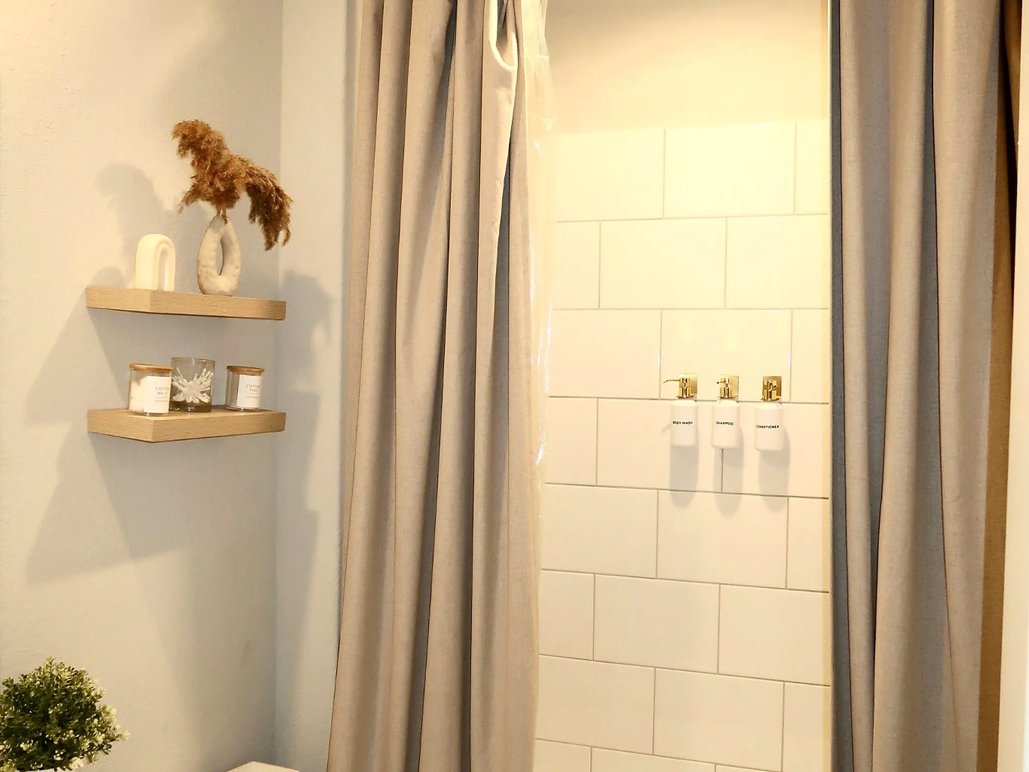 White subway tile shower surround with wall-mounted dispensers