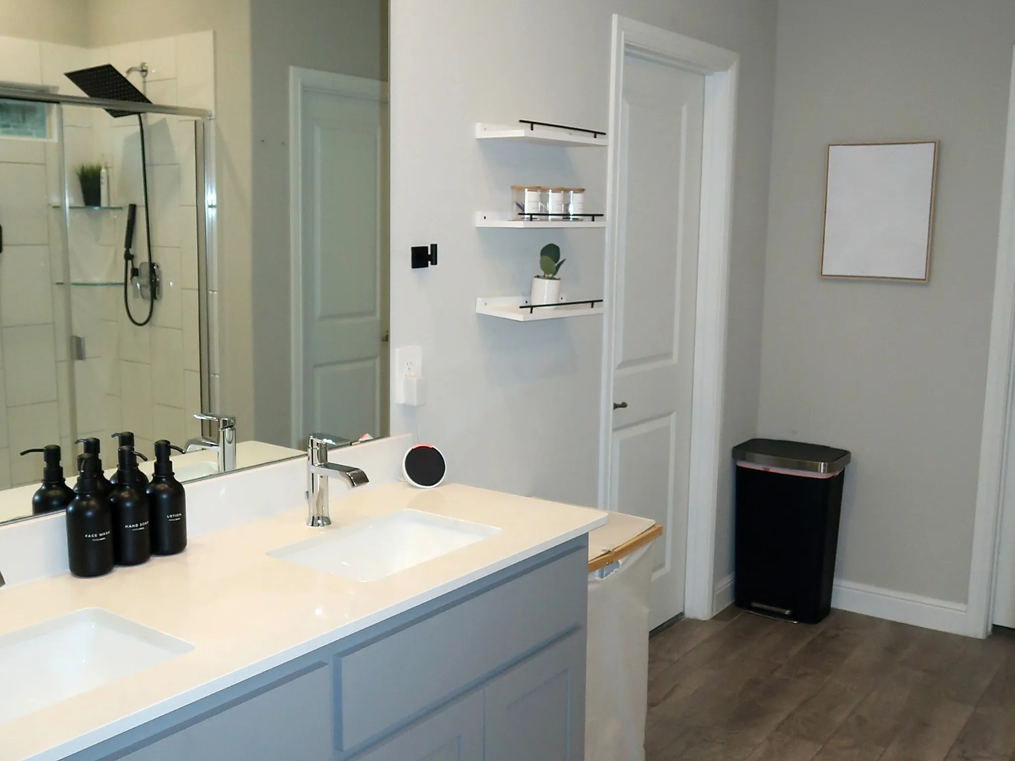 Dual vanity with undermount sinks, chrome faucets, and light-toned countertops