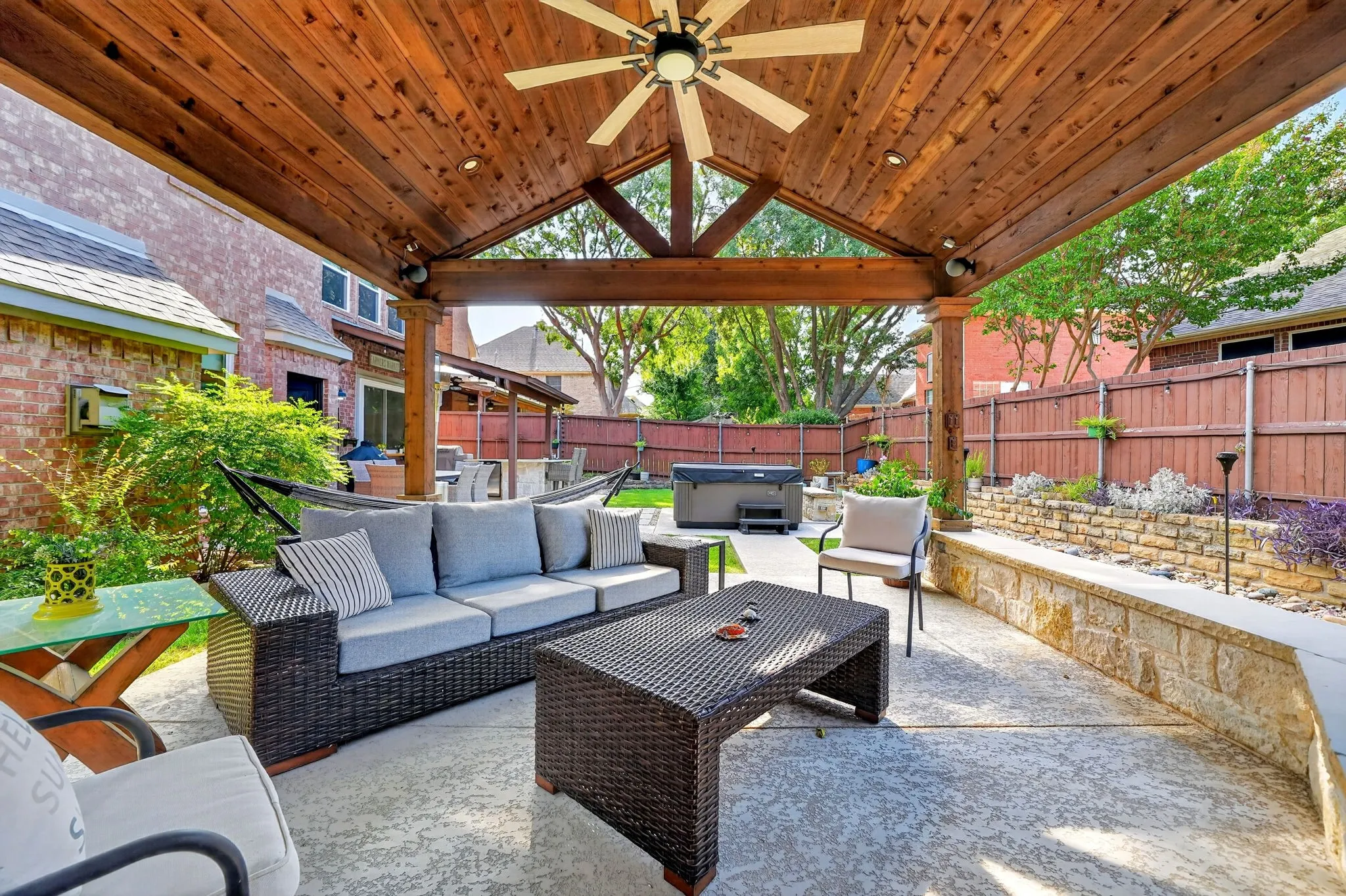 Expansive covered patio featuring a wood-finish ceiling, ceiling fan, and recessed lighting