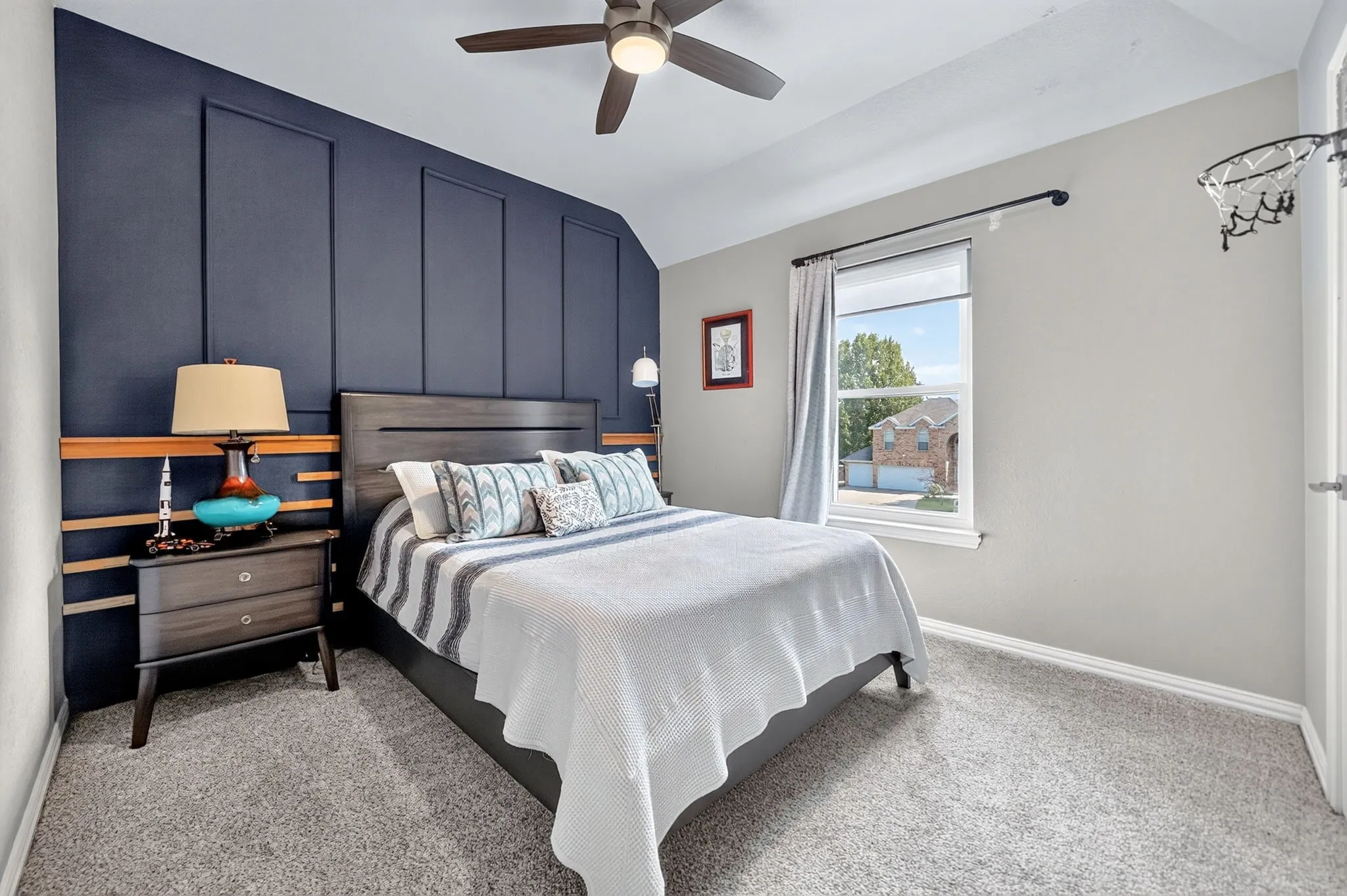 Accent wall with decorative paneling and wood-tone trim