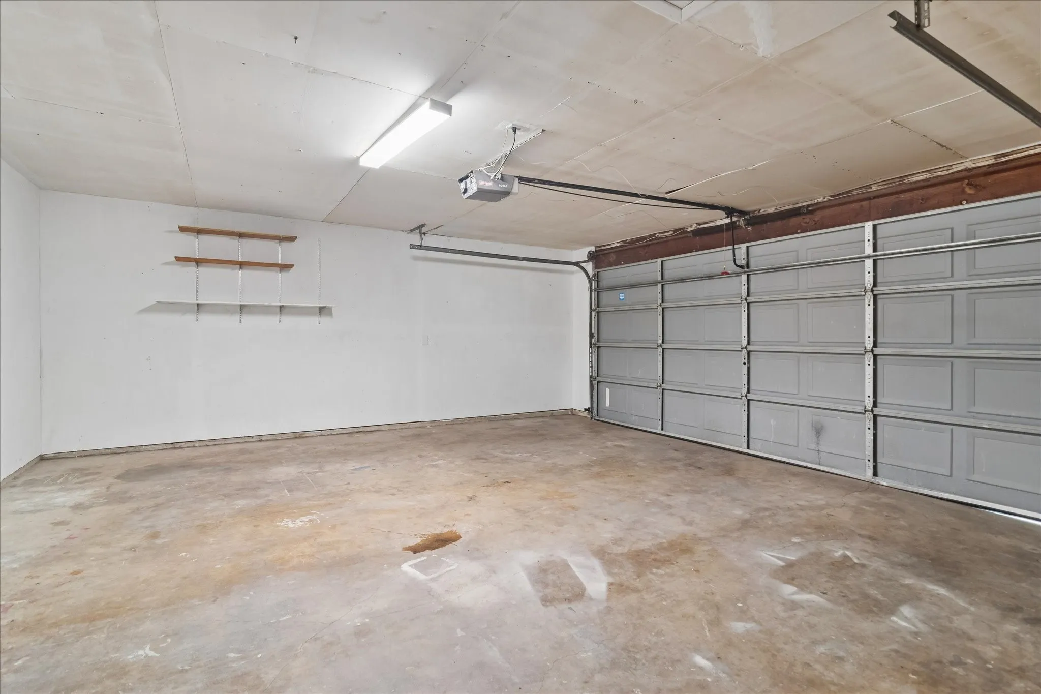 Garage with utility hook ups for a washer and dryer.