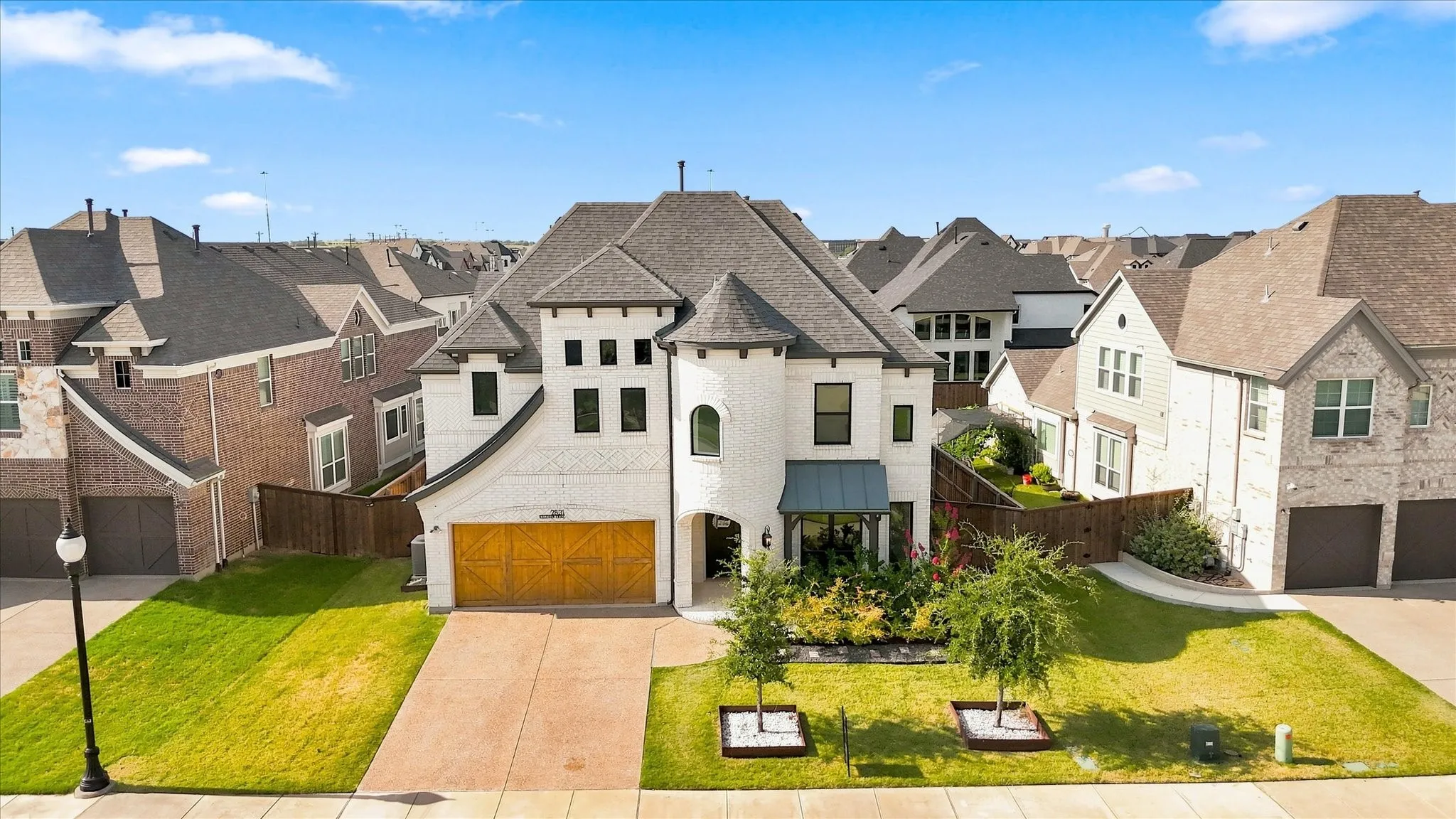 Light brick exterior with a dark shingle roof