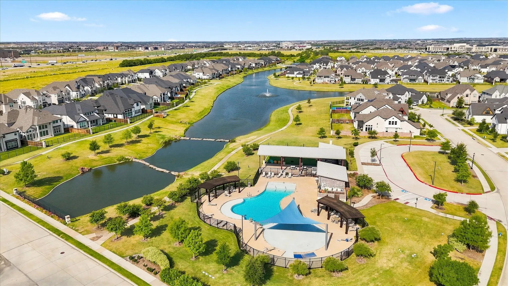 Community pool with a shaded lounging area