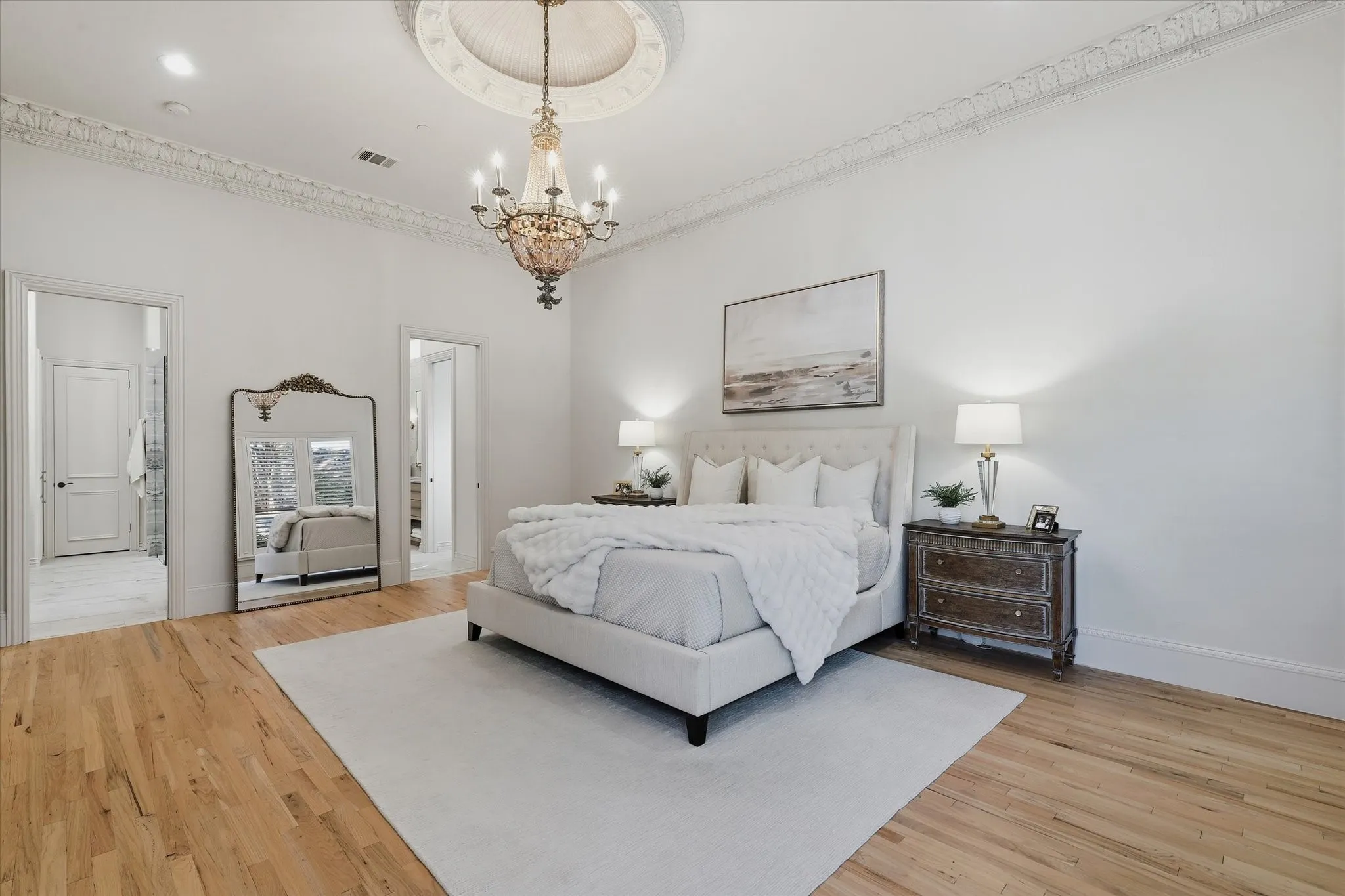 Refinished hardwood floors and detailed millwork complete the serene and spacious primary suite.