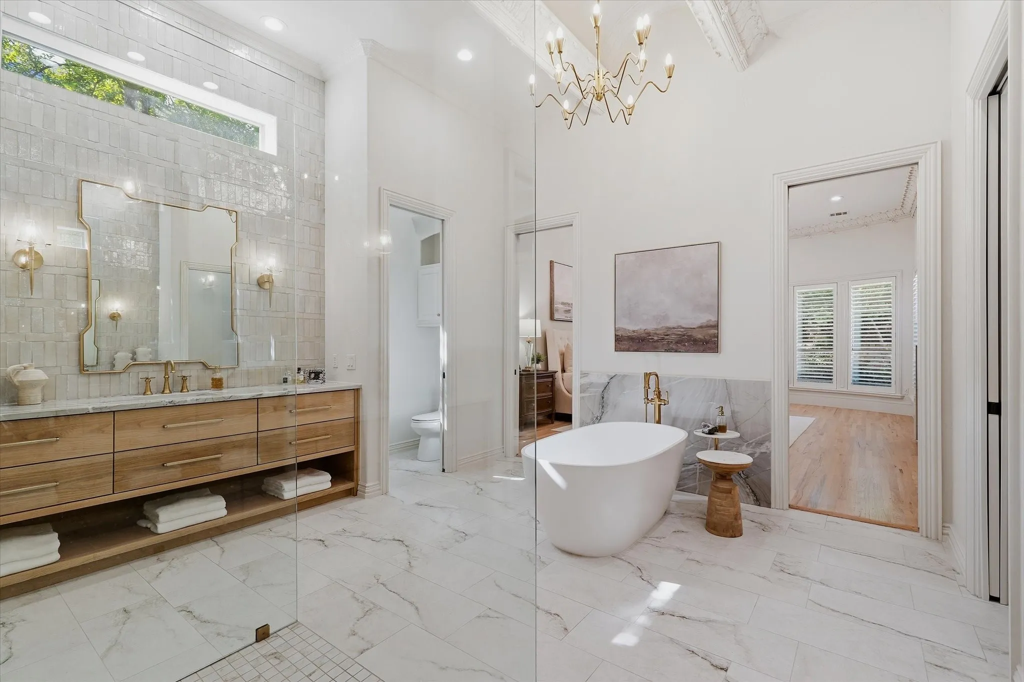 Designed for two, the primary bath includes separate vanities, private water closets and individual custom closets.