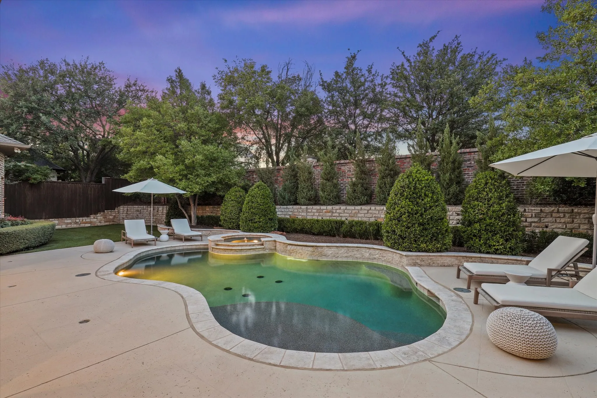 The updated PebbleTec pool is framed by new decking, a stone feature wall and mature landscaping for the ultimate privacy.