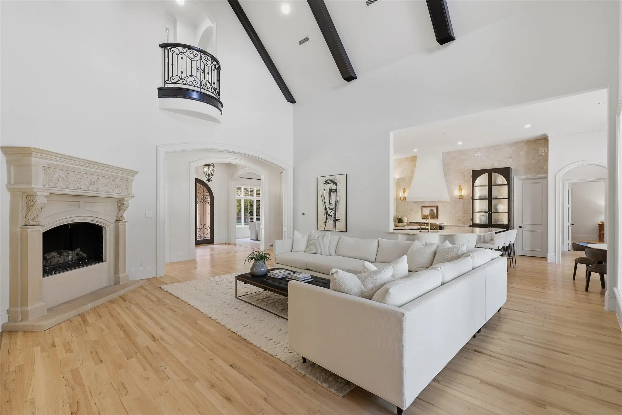 The family room's almost eight-foot cast-stone fireplace anchors the open living and entertaining spaces.