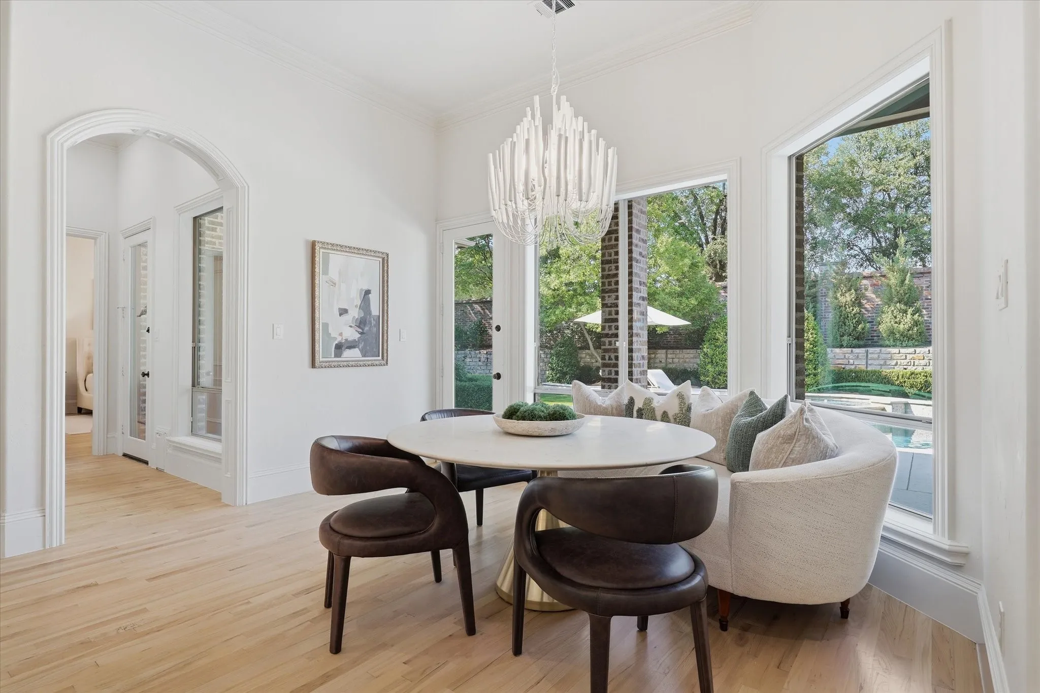 The spacious breakfast area is wrapped in windows overlooking the pool and​​‌​​​​‌​​‌‌​‌‌​​​‌‌​‌​‌​‌​​​‌​​ backyard.