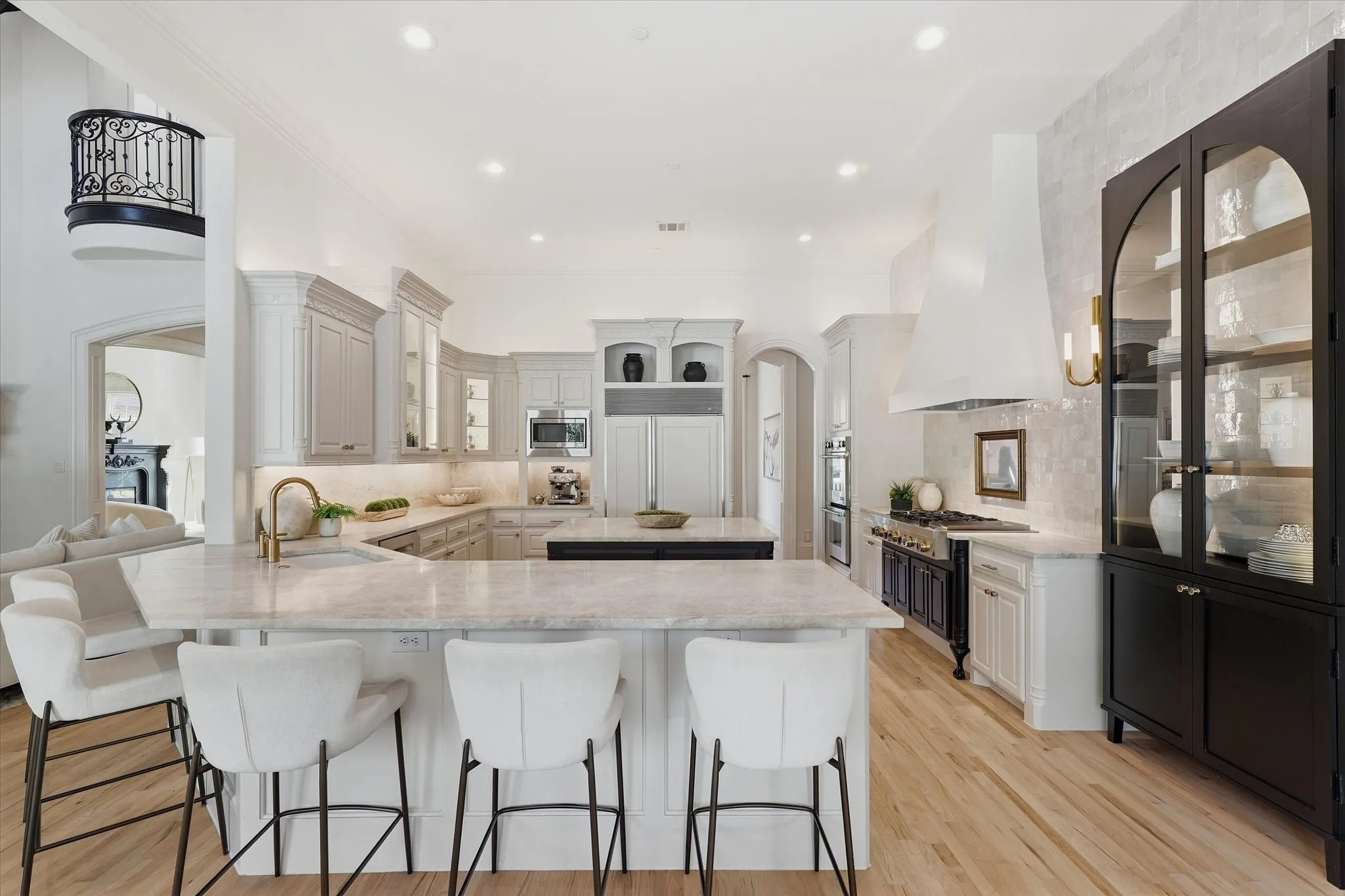 The remodeled kitchen offers generous Taj Mahal quartzite island seating and an effortless connection to the family room.