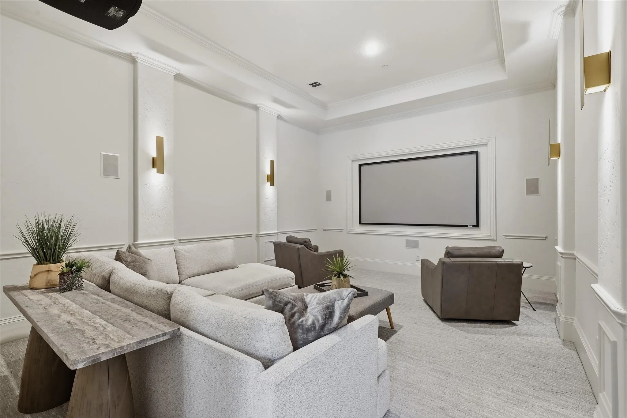 The main-level media room offers a comfortable, dedicated setting for movie nights and game days.