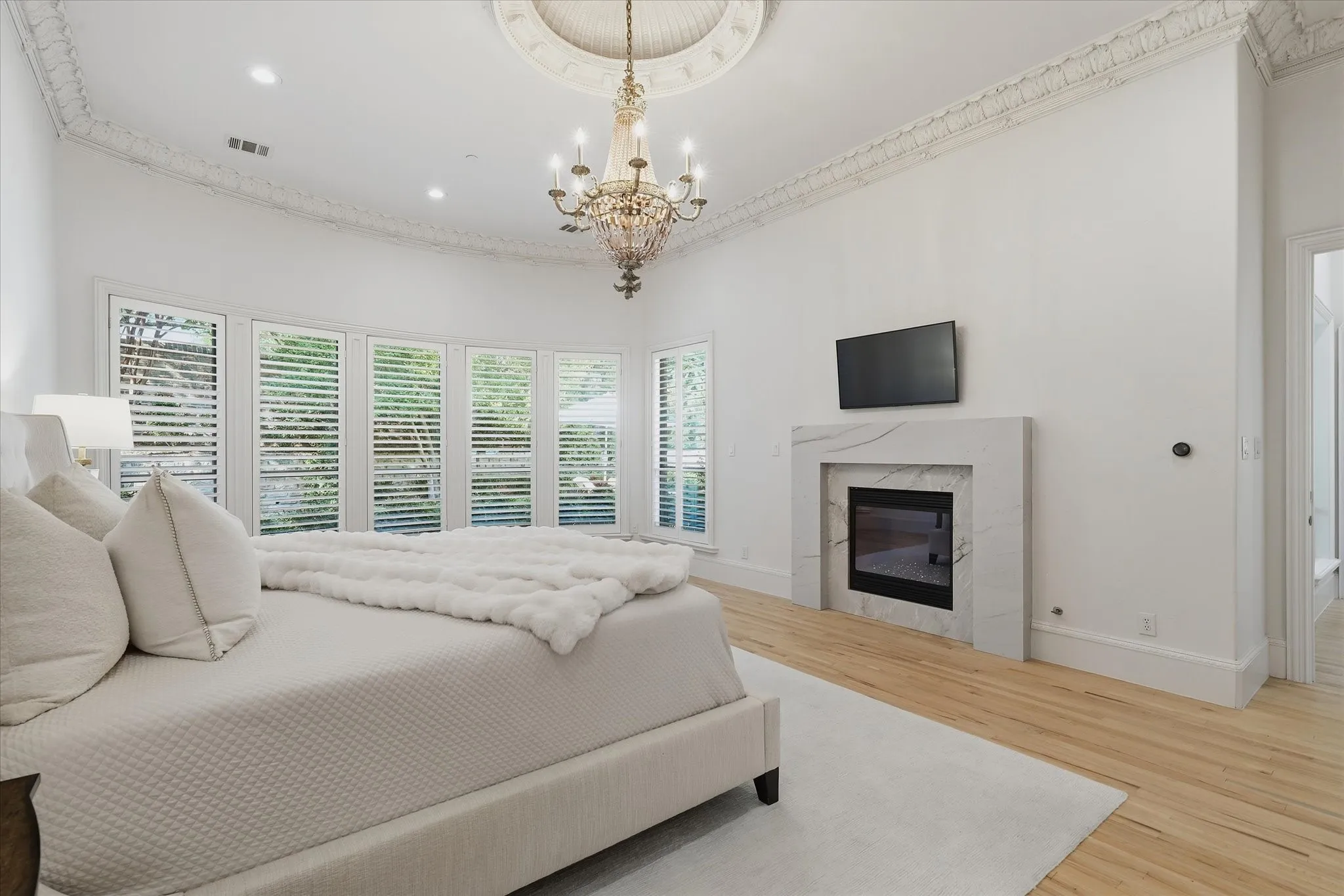 A marble-surround fireplace adds warmth and elegance to the private primary retreat.