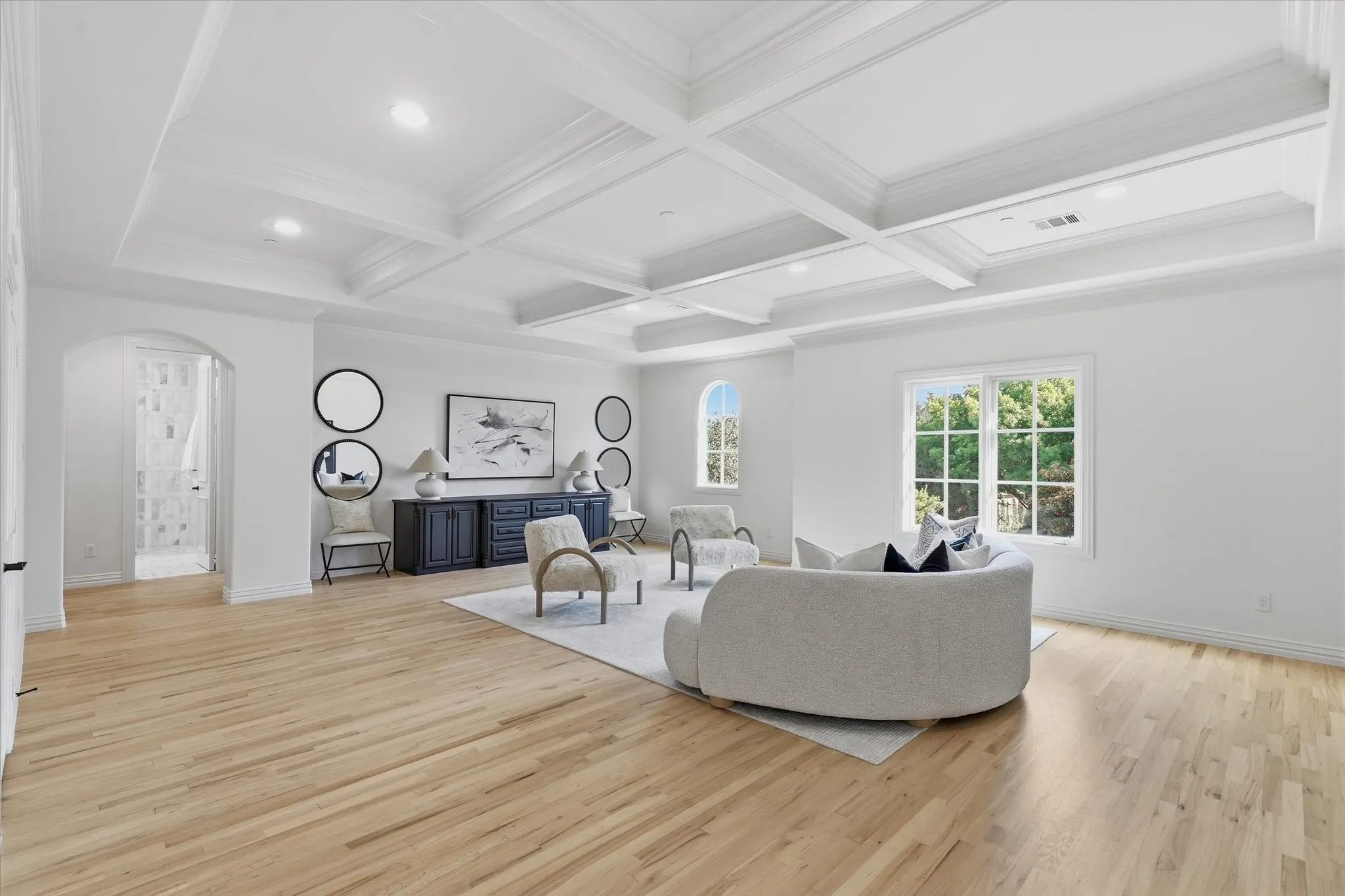 A coffered ceiling brings architectural definition to the expansive upstairs living and game room.