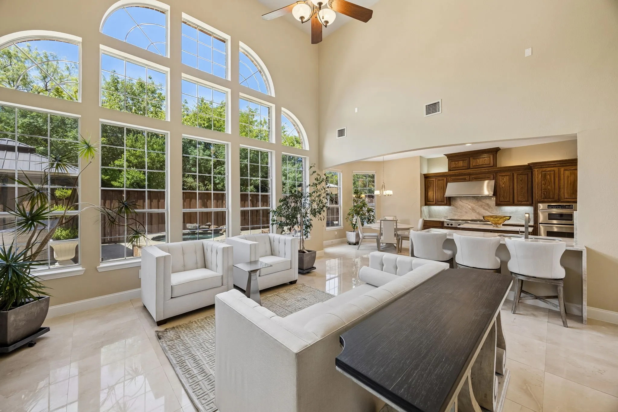The floor to ceiling architectural windows create a seamless connection to the outdoor living area and make this stunning light filled room a true centerpiece of the home.