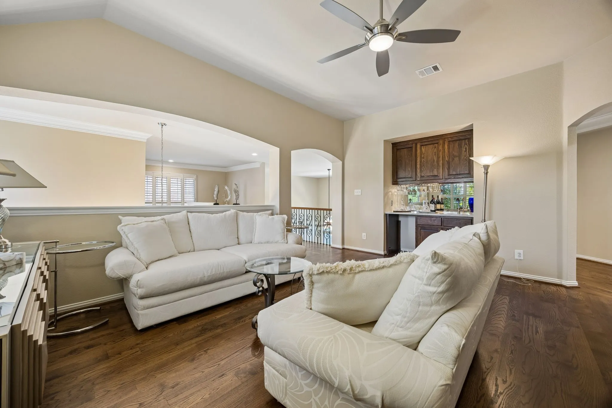 This inviting upstairs living area offers a comfortable setting for relaxing or entertaining, complete with a wet bar and rich solid hardwood floors.