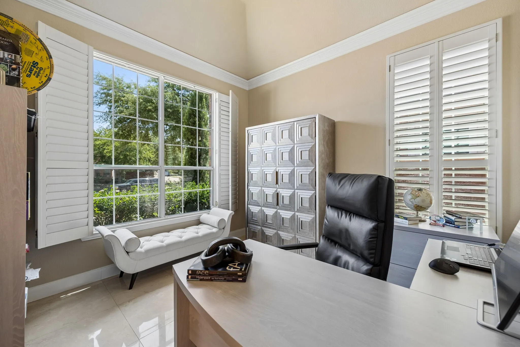 Versatile front living area offers the perfect setting for a work-from-home office.  Generous windows with planation shutters fill the space with light.