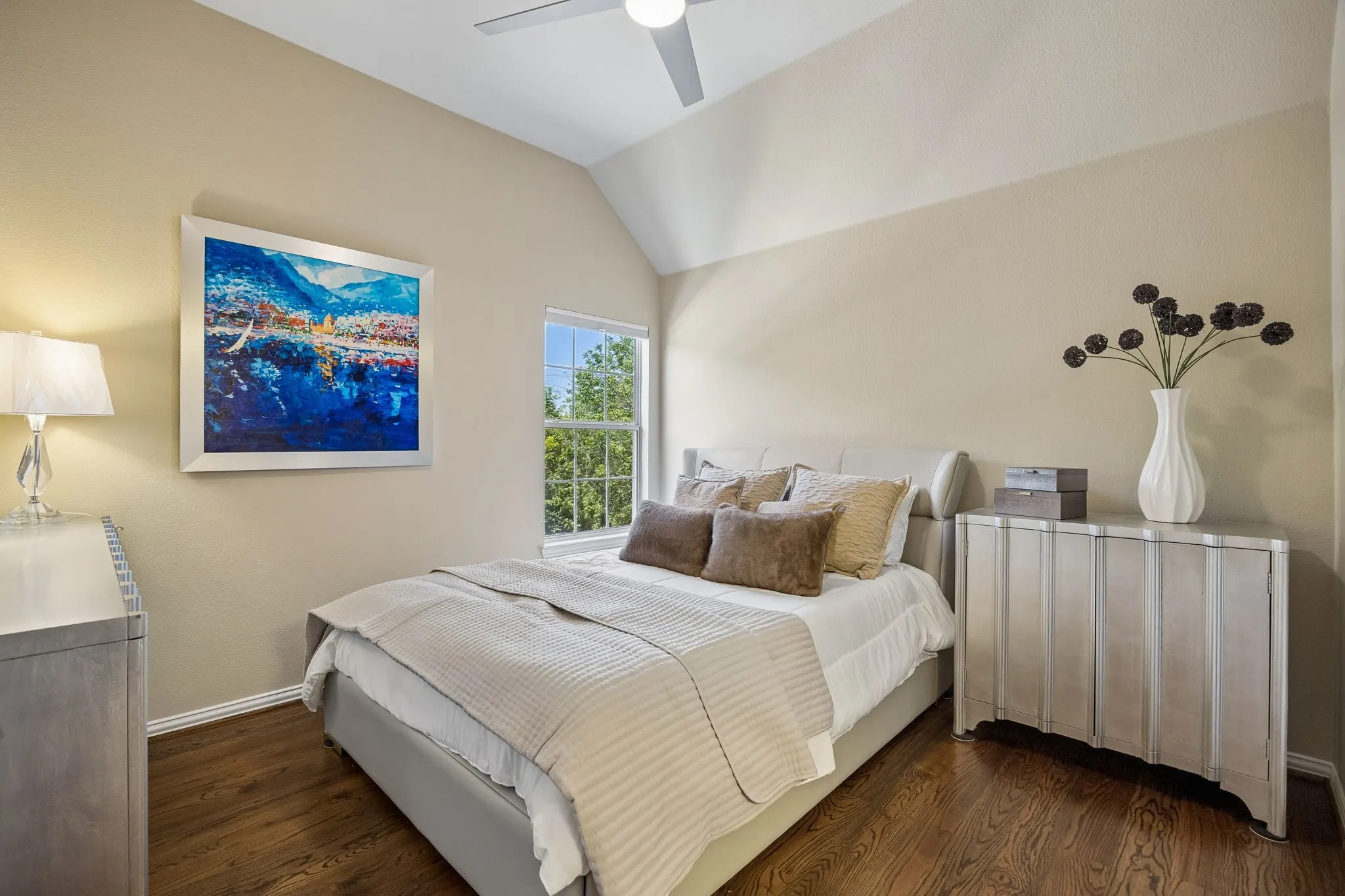 Upstairs, this inviting renovated secondary bedroom features solid hardwood floors, designer paint color and vaulted ceiling.  It has convenient access to the Jack and Jill bath.