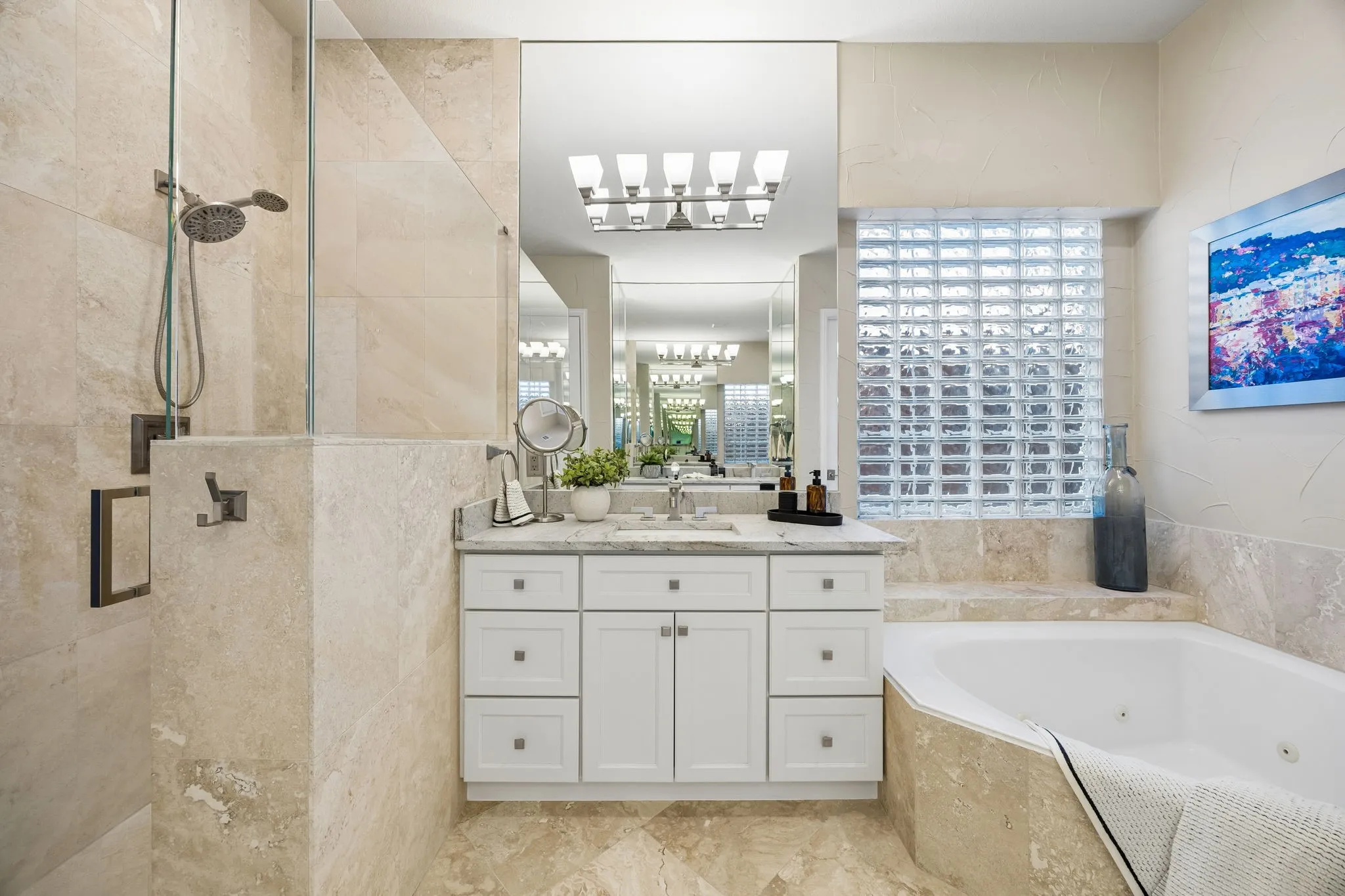 he primary bathroom has a jetted tub, separate shower with pony wall and frameless glass, and a private commode closet that complements the generous layout, making the bathroom have a spa like atmosphere.