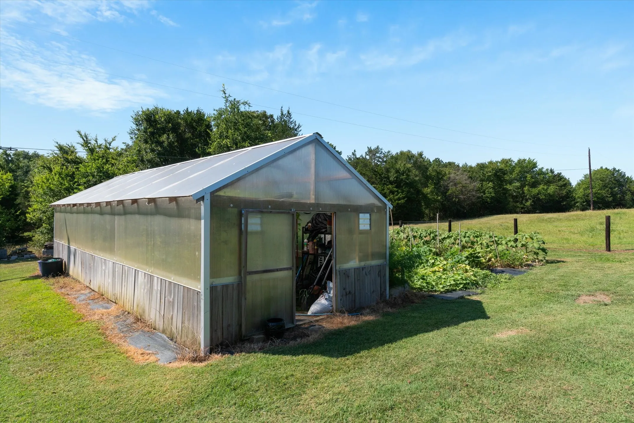 The greenhouse has shelving with evaporative cooling
