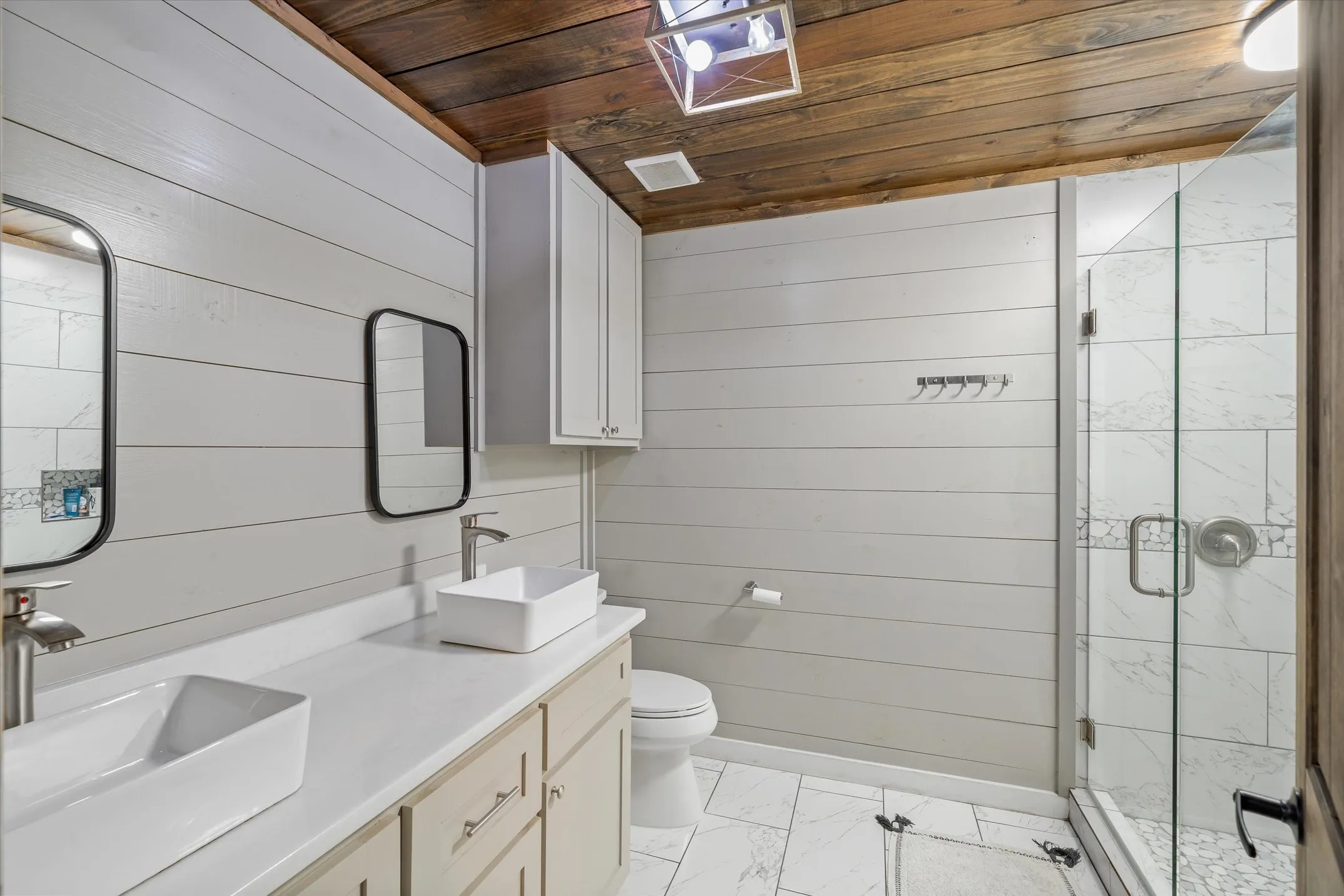 Full bath upstairs with tiled shower and dual sinks