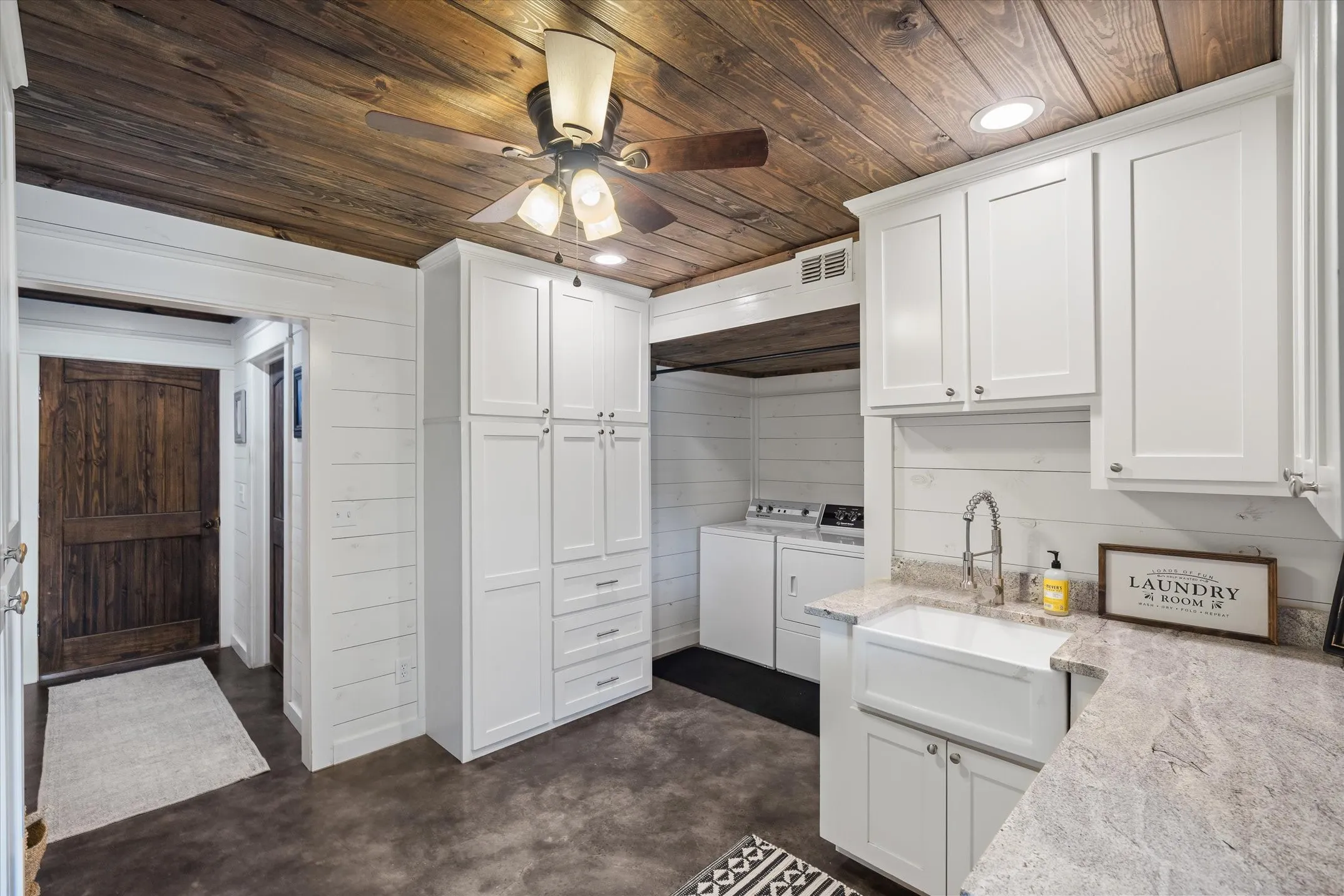 Laundry utility room with sink and has cabinets on every wall for extra pantry space