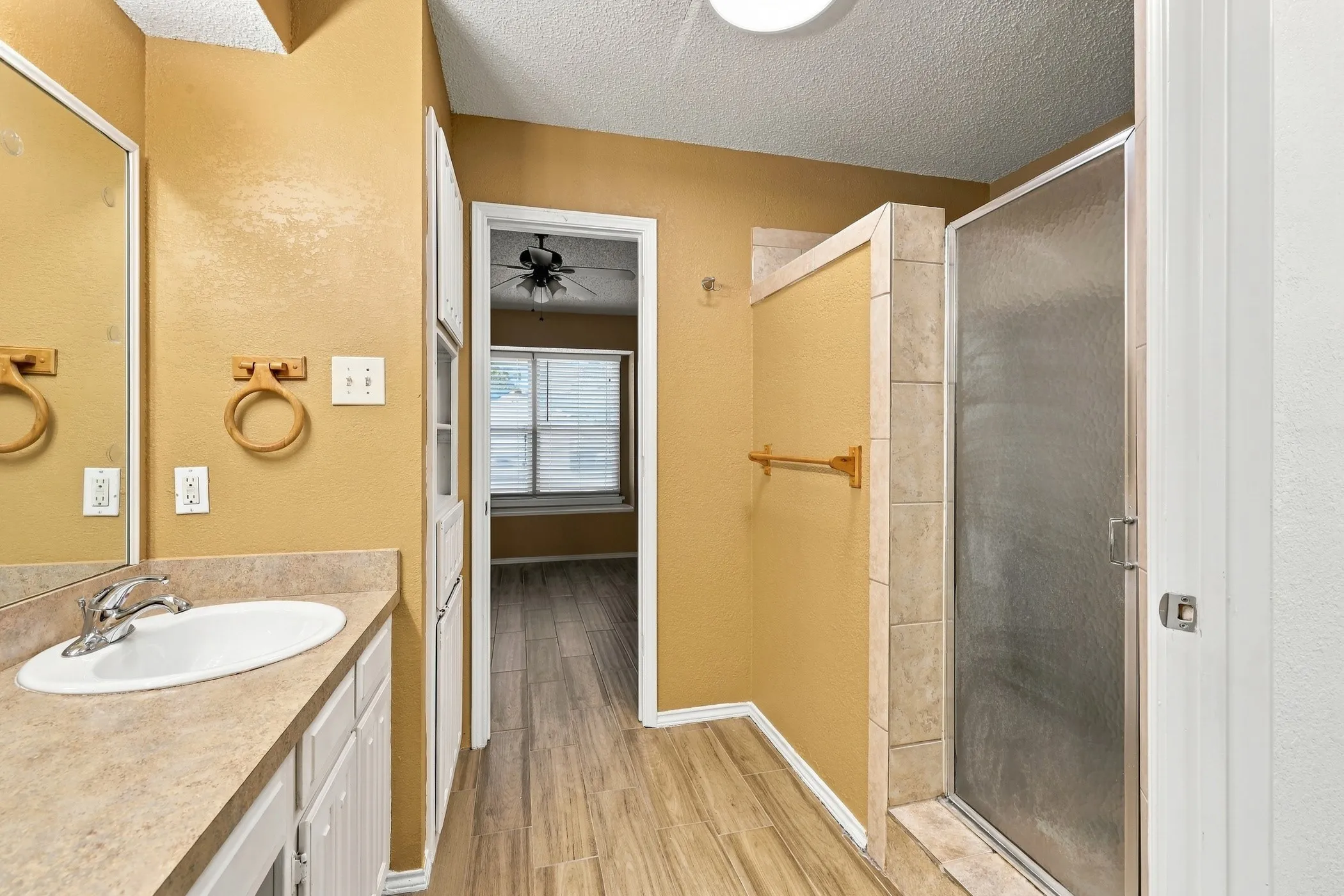 Single vanity with an integrated sink, polished chrome faucet, and ample under-sink storage