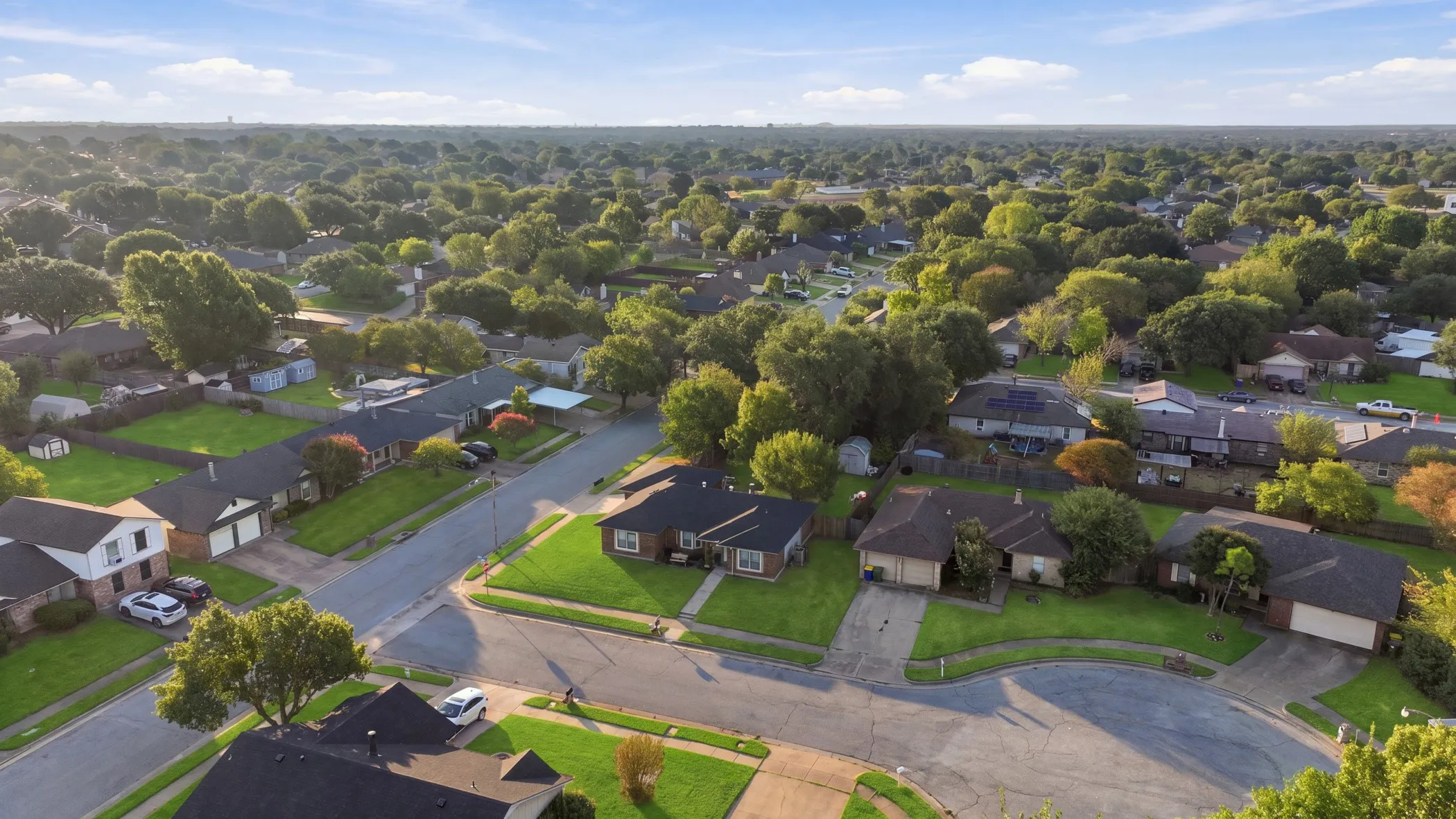 Residential neighborhood with mature trees and paved streets