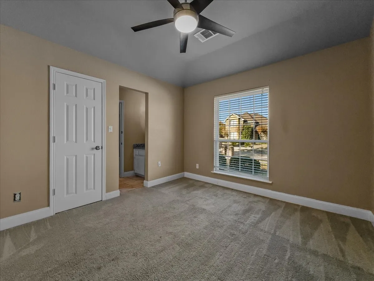 Neutral-toned walls complement plush carpeting