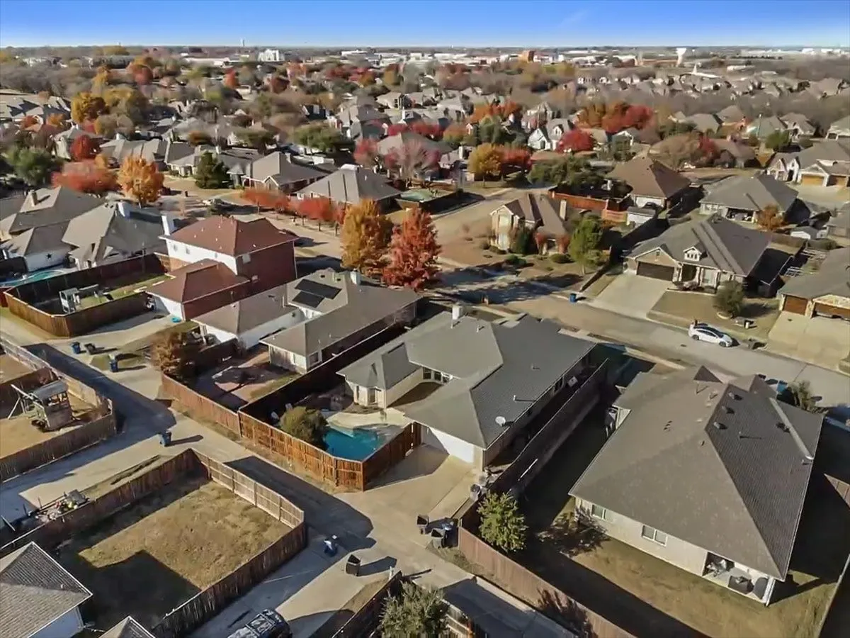 Aerial perspective showcasing a residential neighborhood with varied architectural styles and mature trees