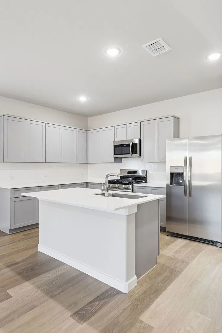 Kitchen in the Haylee home plan by Trophy Signature Homes - REPRESENTATIVE PHOTO