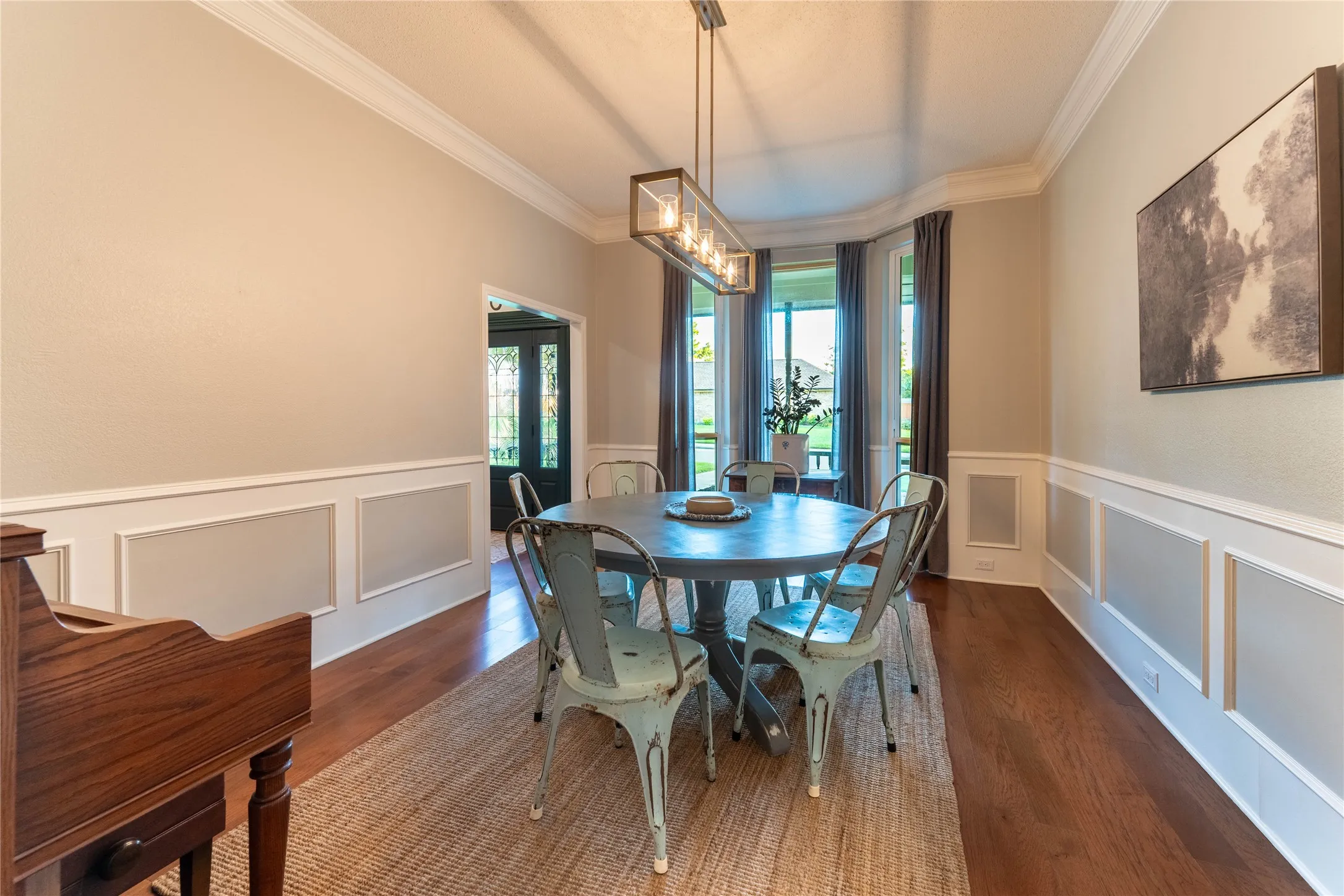 Wood-finish flooring, crown molding, and wainscoting details