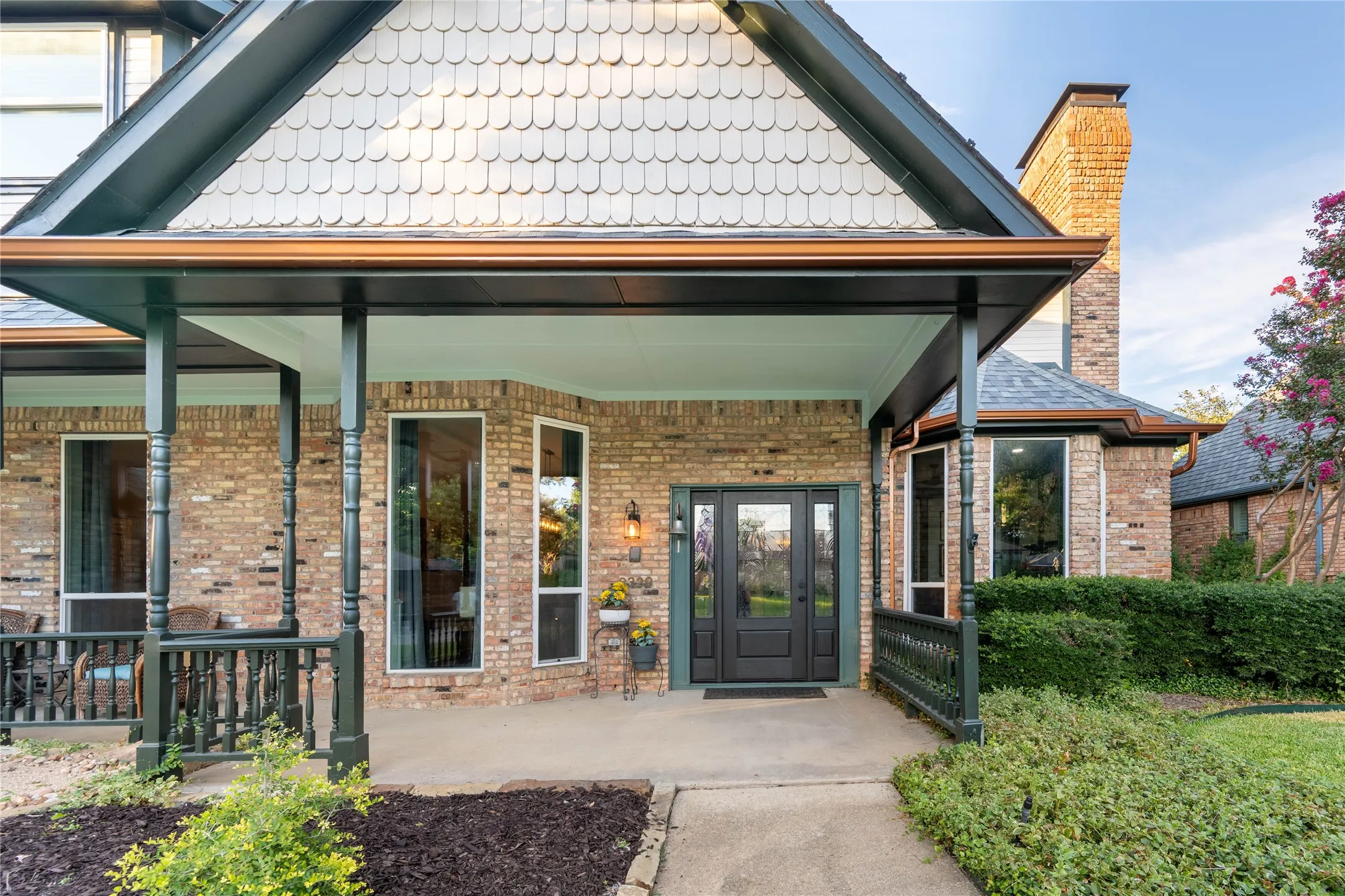 Brick exterior with gabled roofline and decorative shingle siding