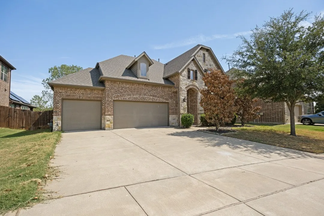 Brick and stone exterior with a two-car garage