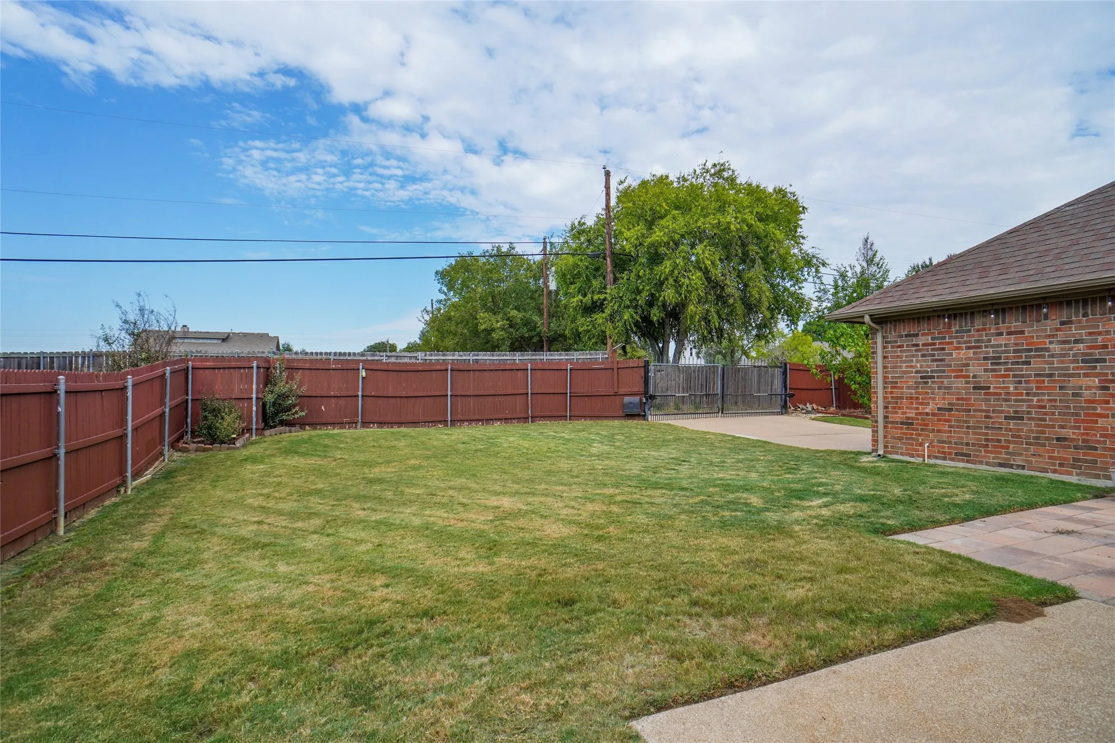 Fenced backyard with a patio area