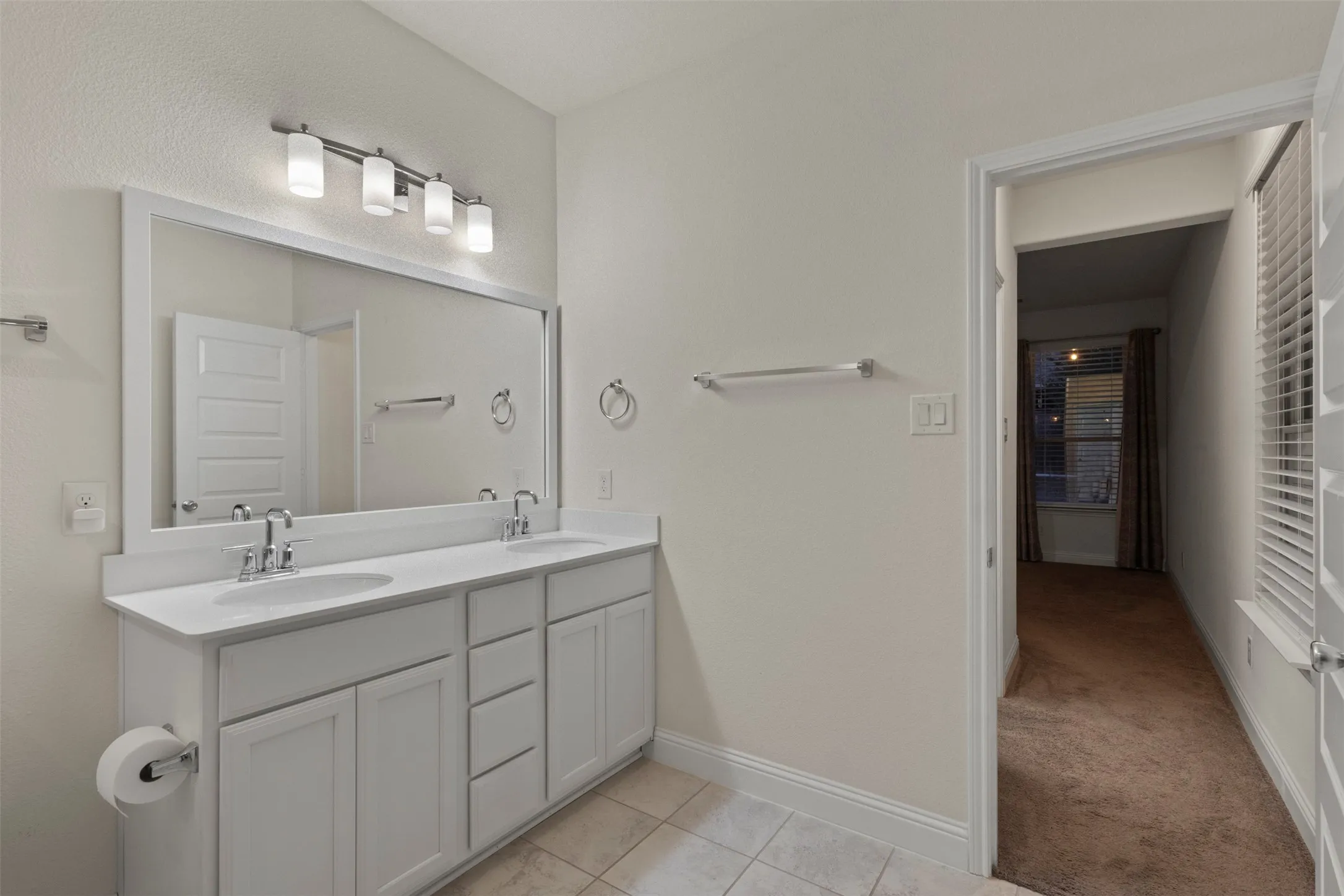Double vanity with undermount sinks and chrome fixtures