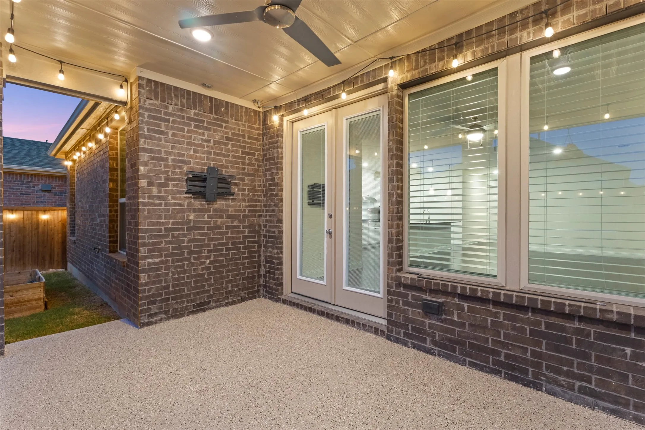 Covered patio featuring a ceiling fan, recessed lighting, and string lights