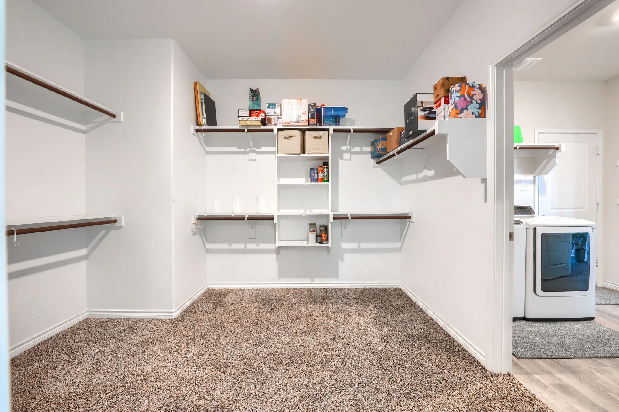 Wall-mounted shelving system with hanging rods and built-in cubbies