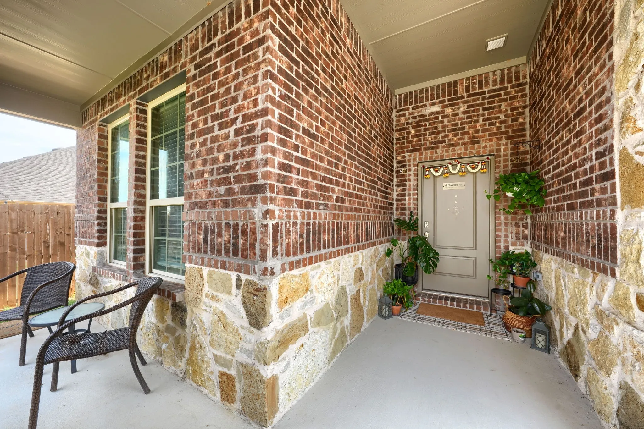 Brick and stone exterior with a covered entry