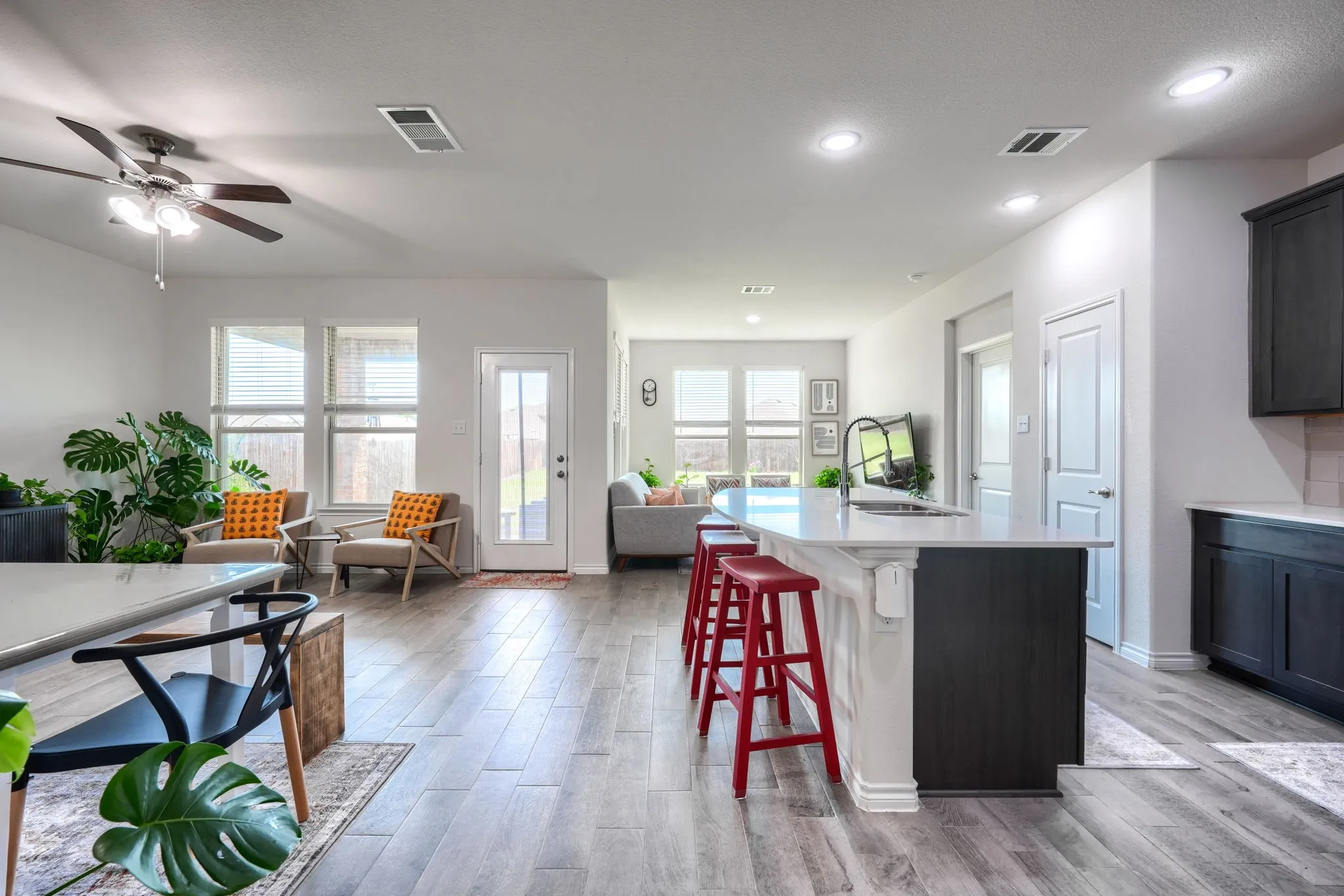Open-concept interior featuring wood-finish flooring, recessed lighting, and a ceiling fan