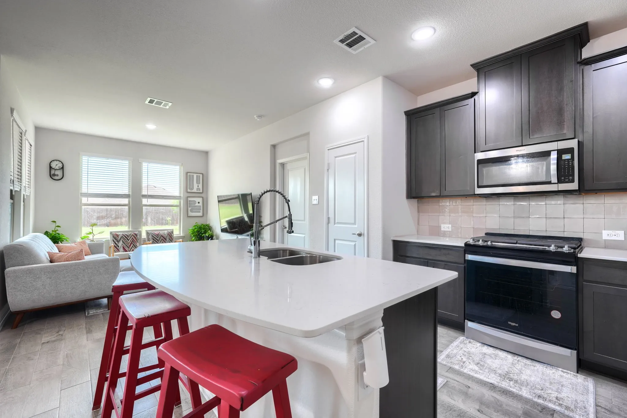 Kitchen island with a white countertop and double basin sink