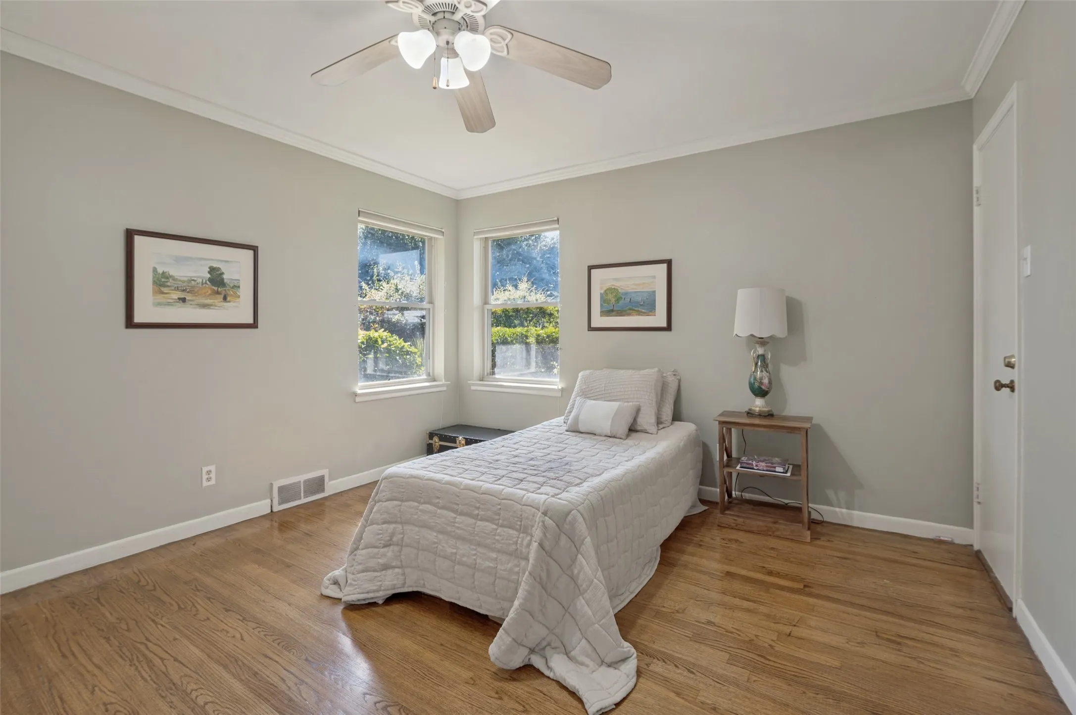 Hardwood flooring, painted walls, crown molding, double windows, ceiling fan