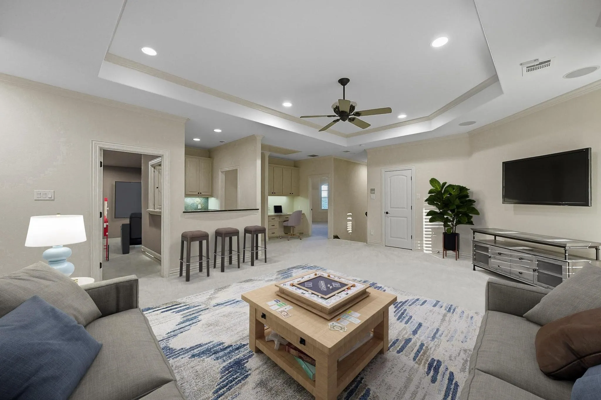 Upstairs, enjoy a huge game room with a wet bar area. This photo has been virtually staged