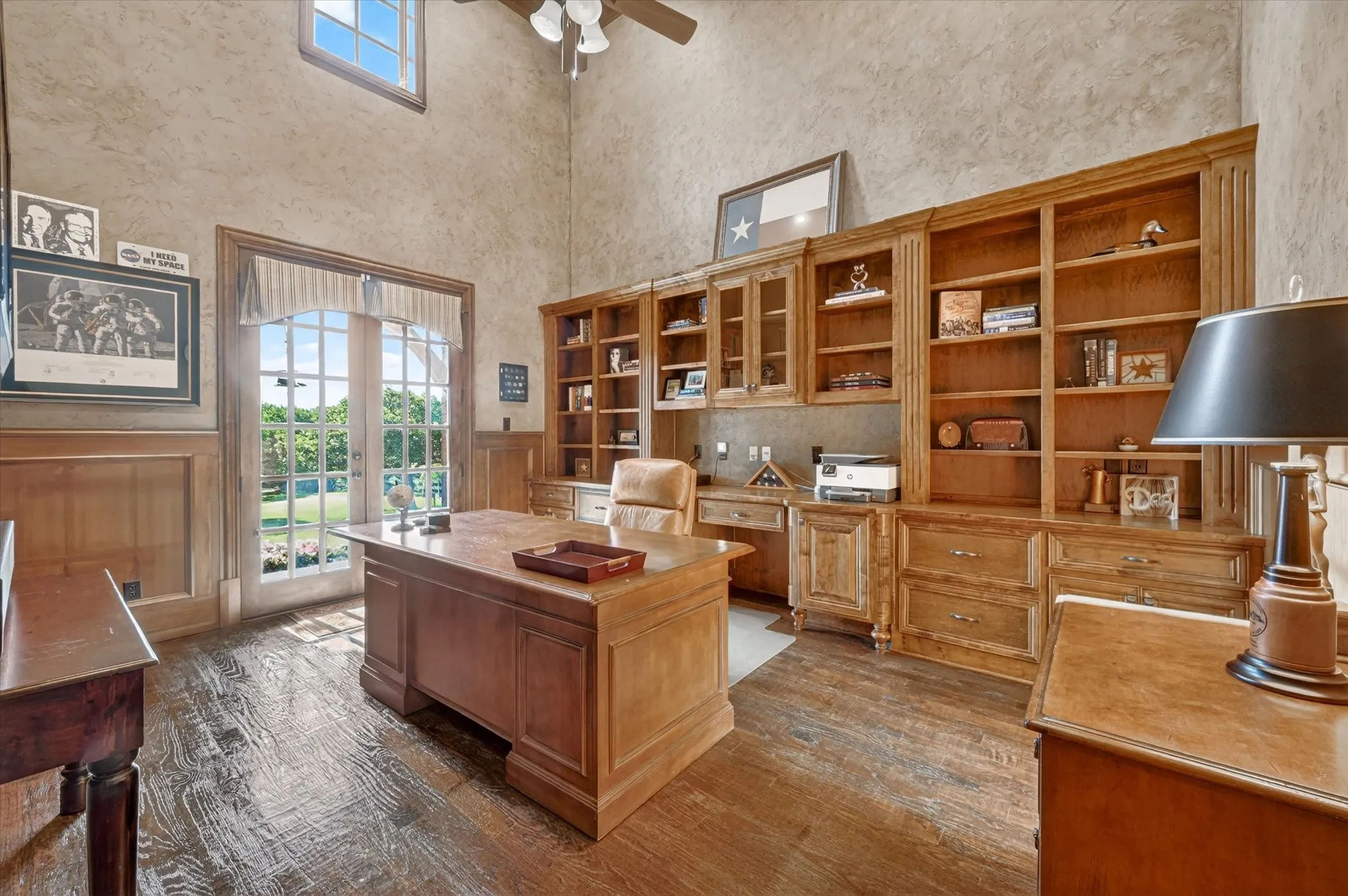 A Texas-style office with Mediterranean flair sits off the foyer, offering French door views of the front acreage.
