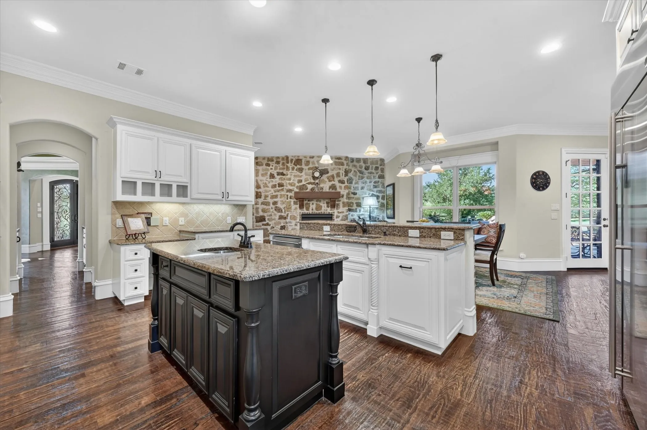 Brick & stone features highlight the inviting feel of the open family room & breakfast area, with a formal dining room for special occasions.