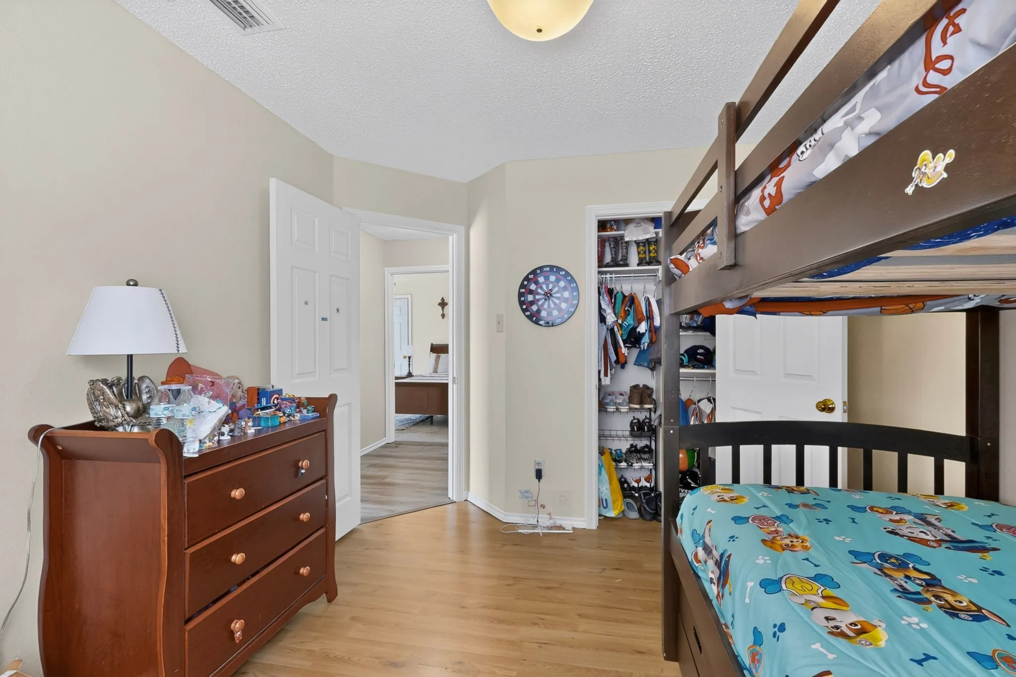 Wood-finish flooring throughout, recessed lighting, and a built-in closet with shelving