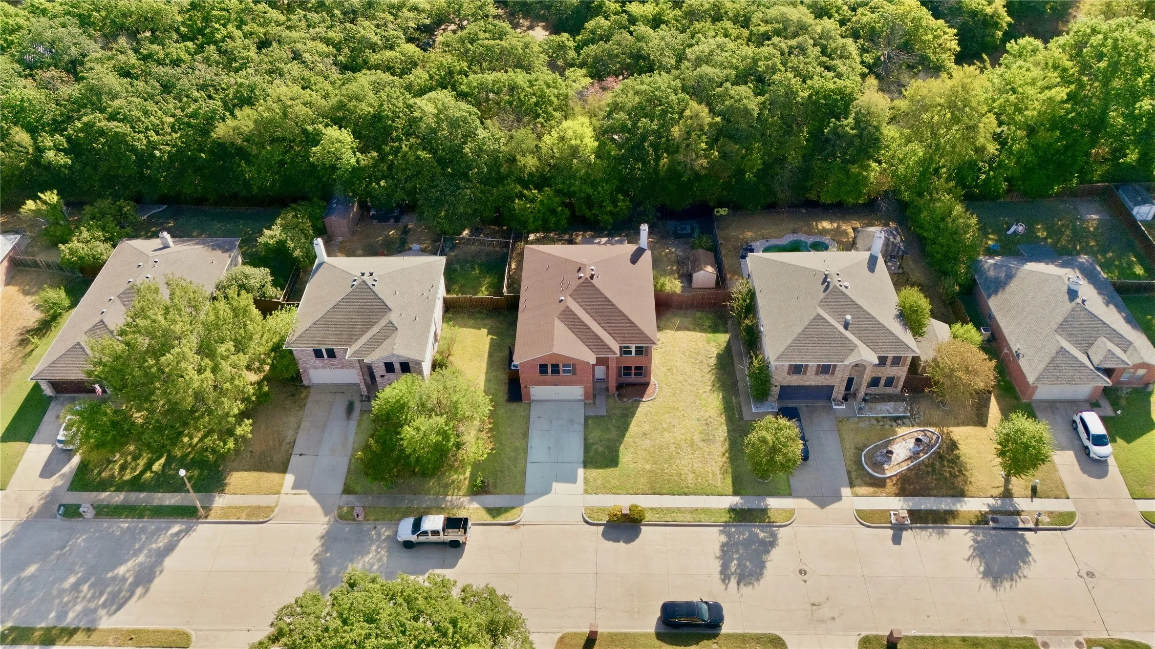 Two-story residence featuring a brick facade, gabled roof, and attached two-car garage