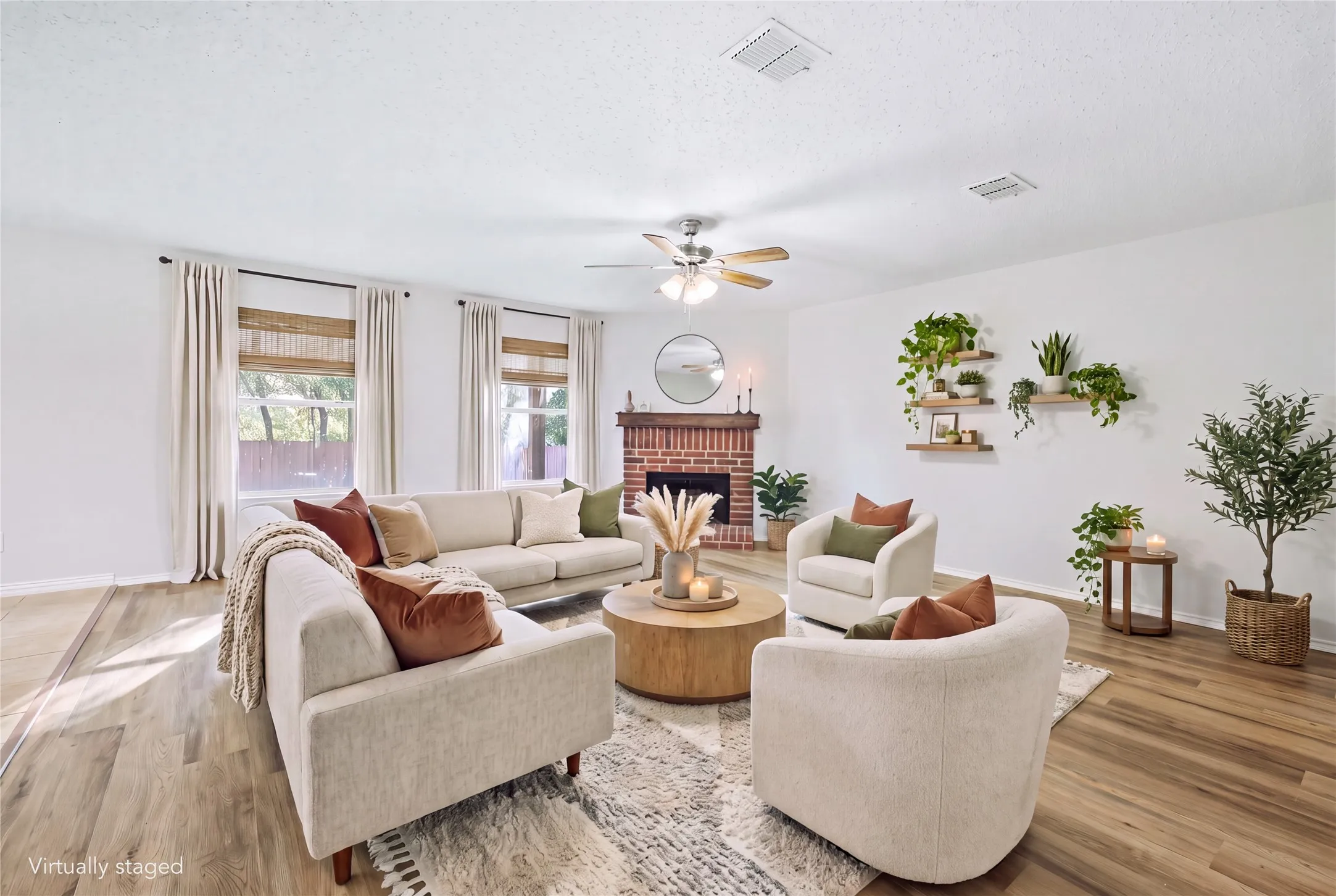 Hard-surface flooring, brick fireplace, ceiling fan, multiple windows, and recessed lighting