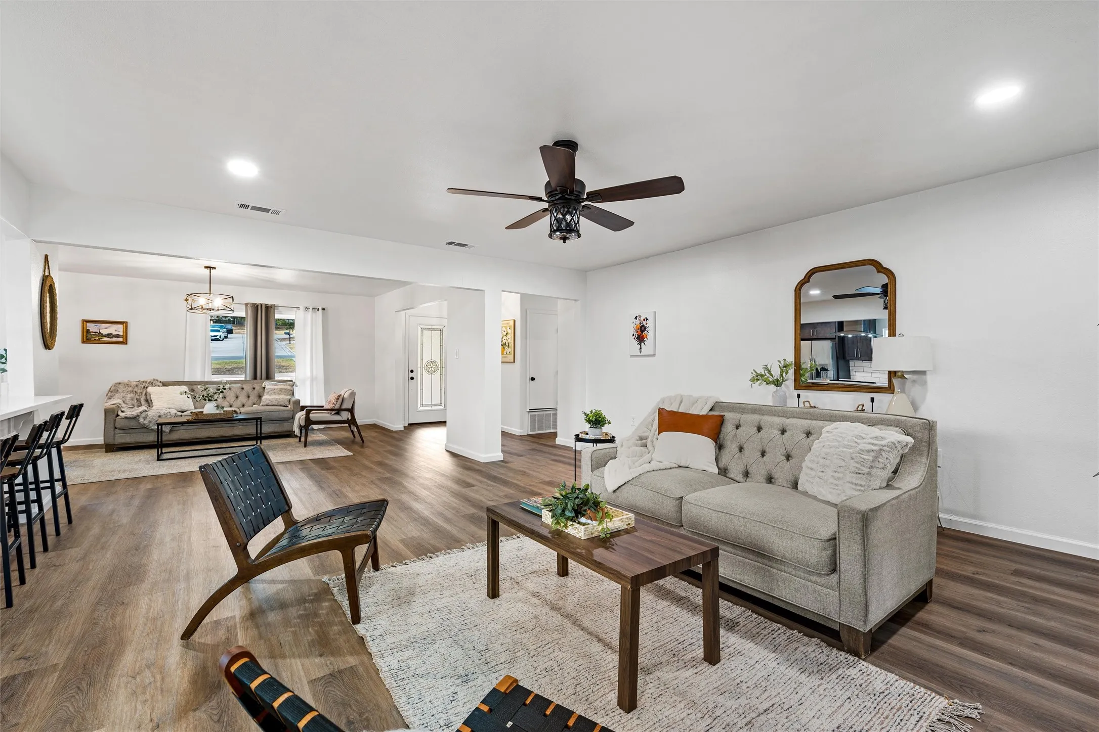Wood-finish flooring, recessed lighting, and a ceiling fan with integrated light