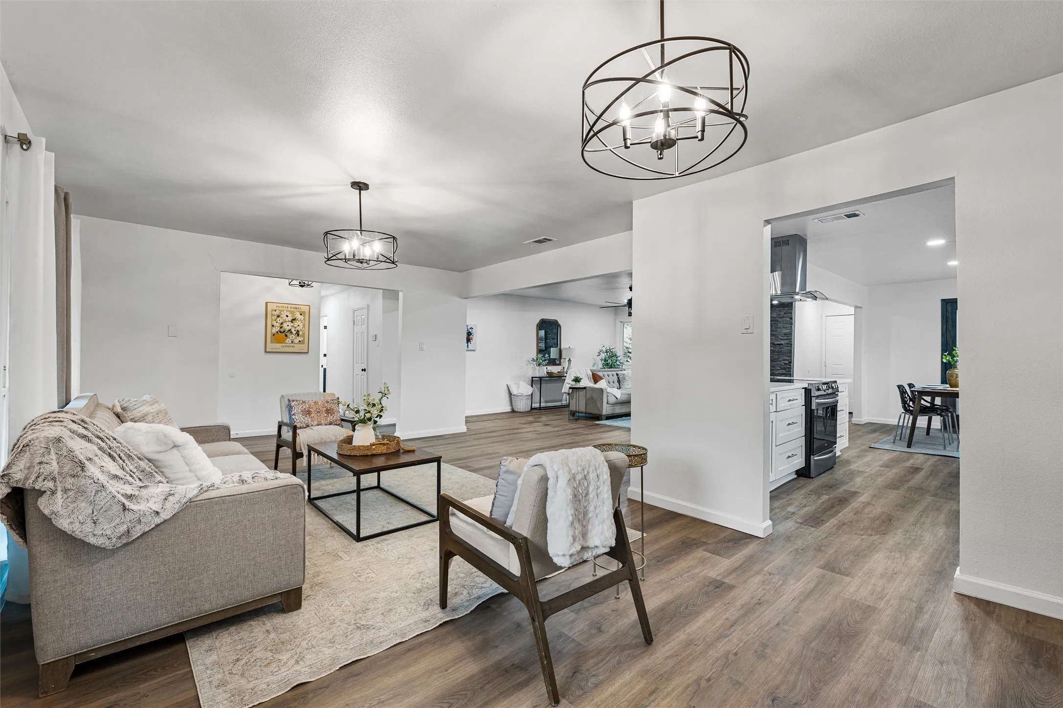 Open concept living area with wood-finish flooring