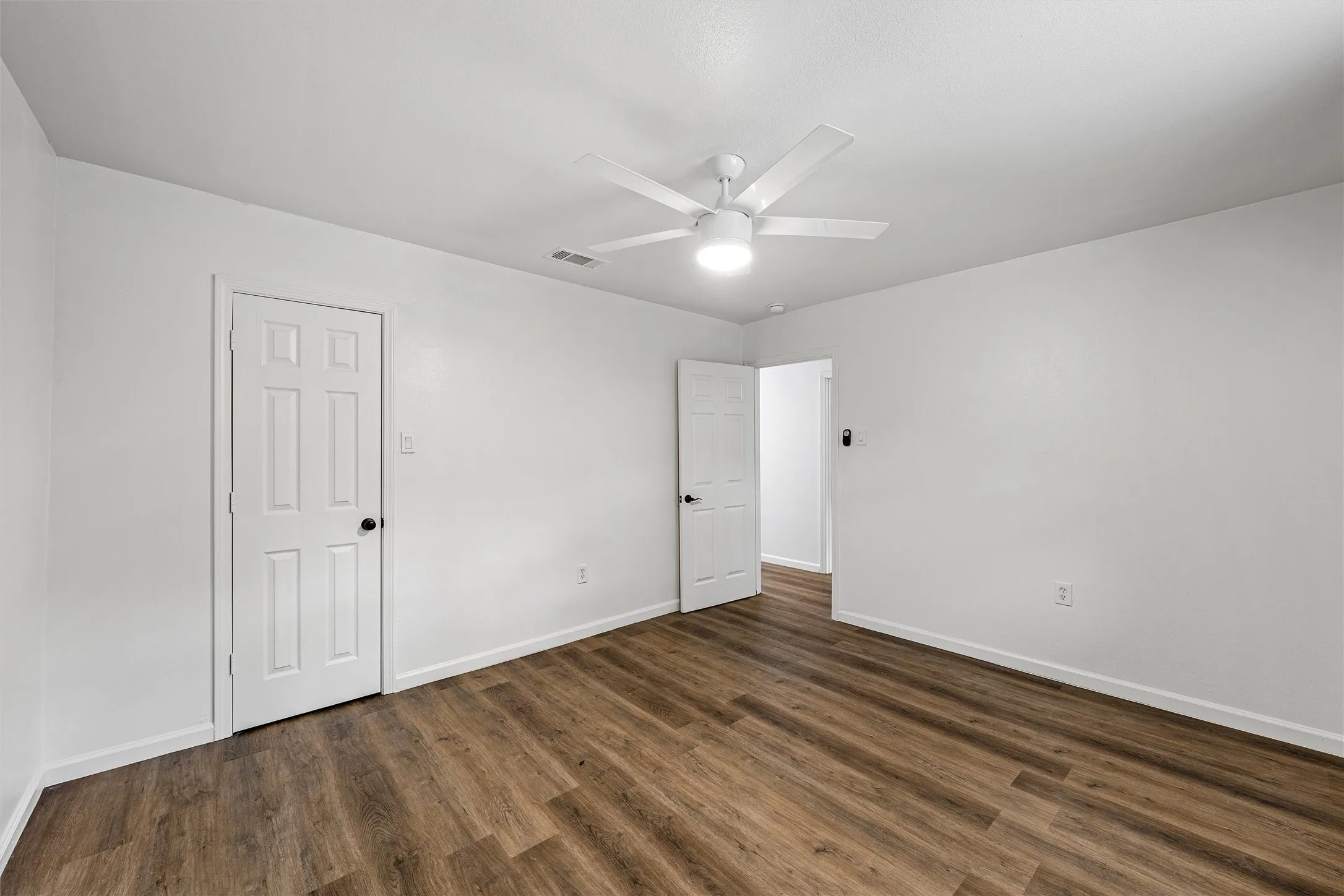 Wood-finish flooring with crisp white walls and white trim