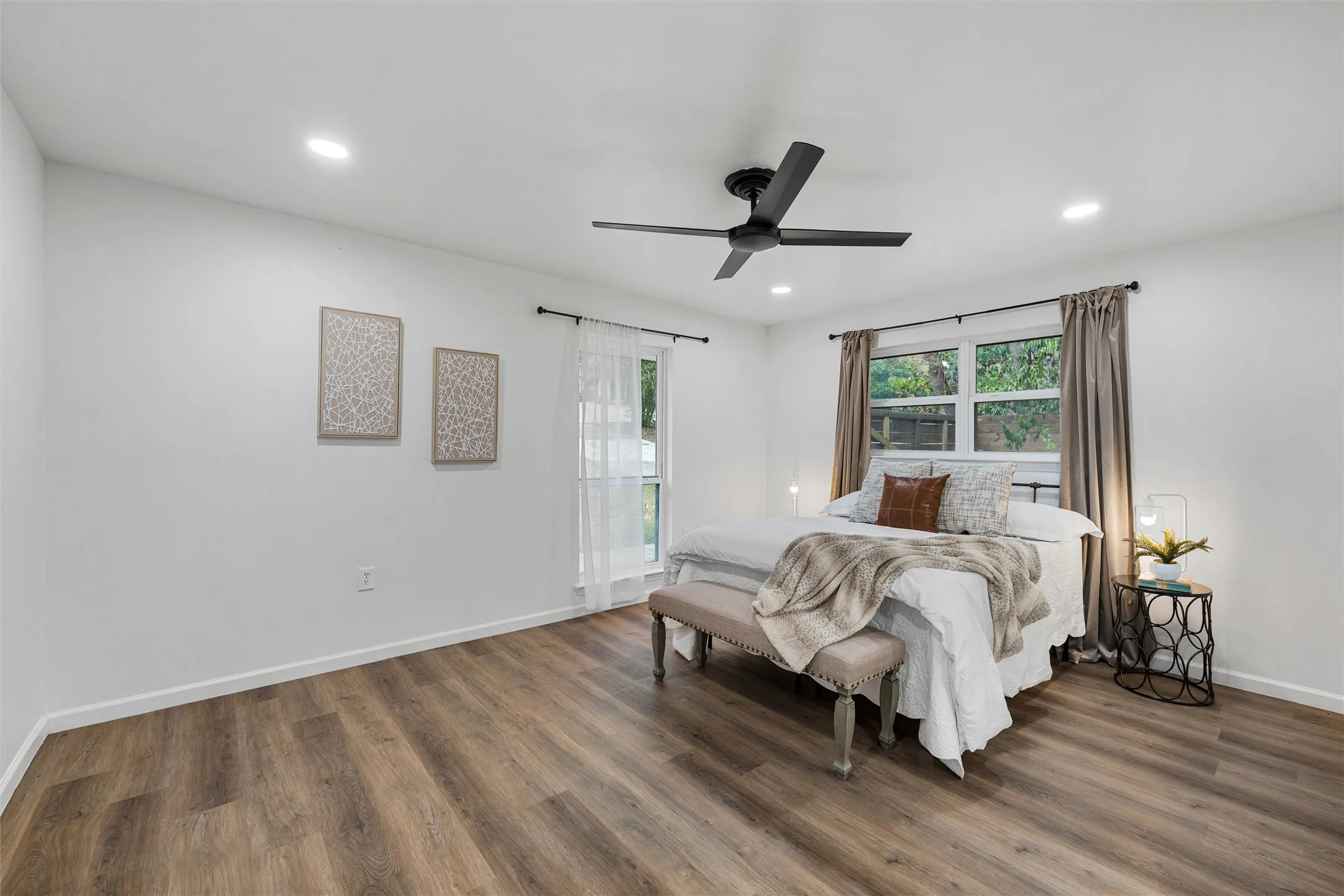 Wood-finish flooring, recessed lighting, and a contemporary ceiling fan